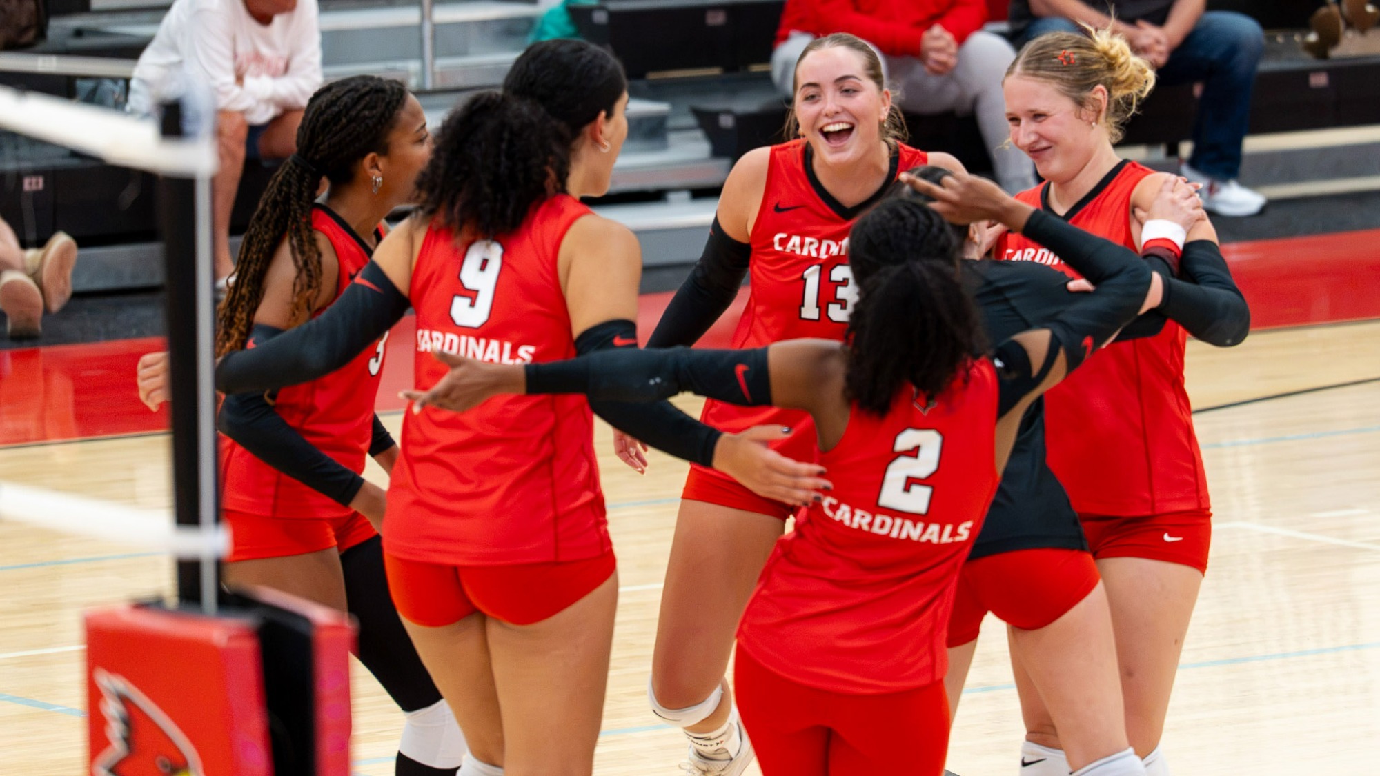 Team photo of Plattsburgh State Women's Volleyball on court