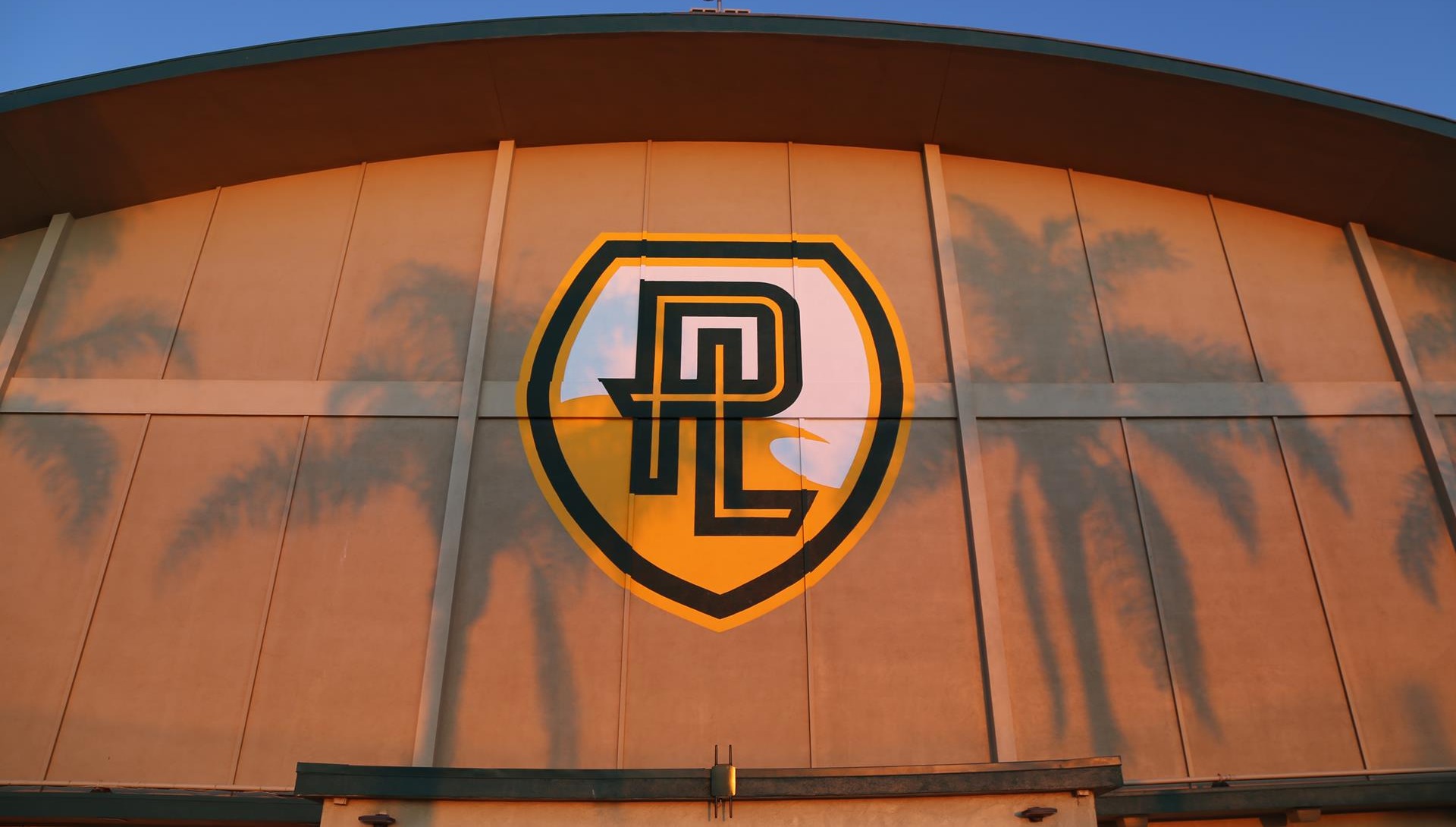 Golden Gym PLNU with shadows of palm trees