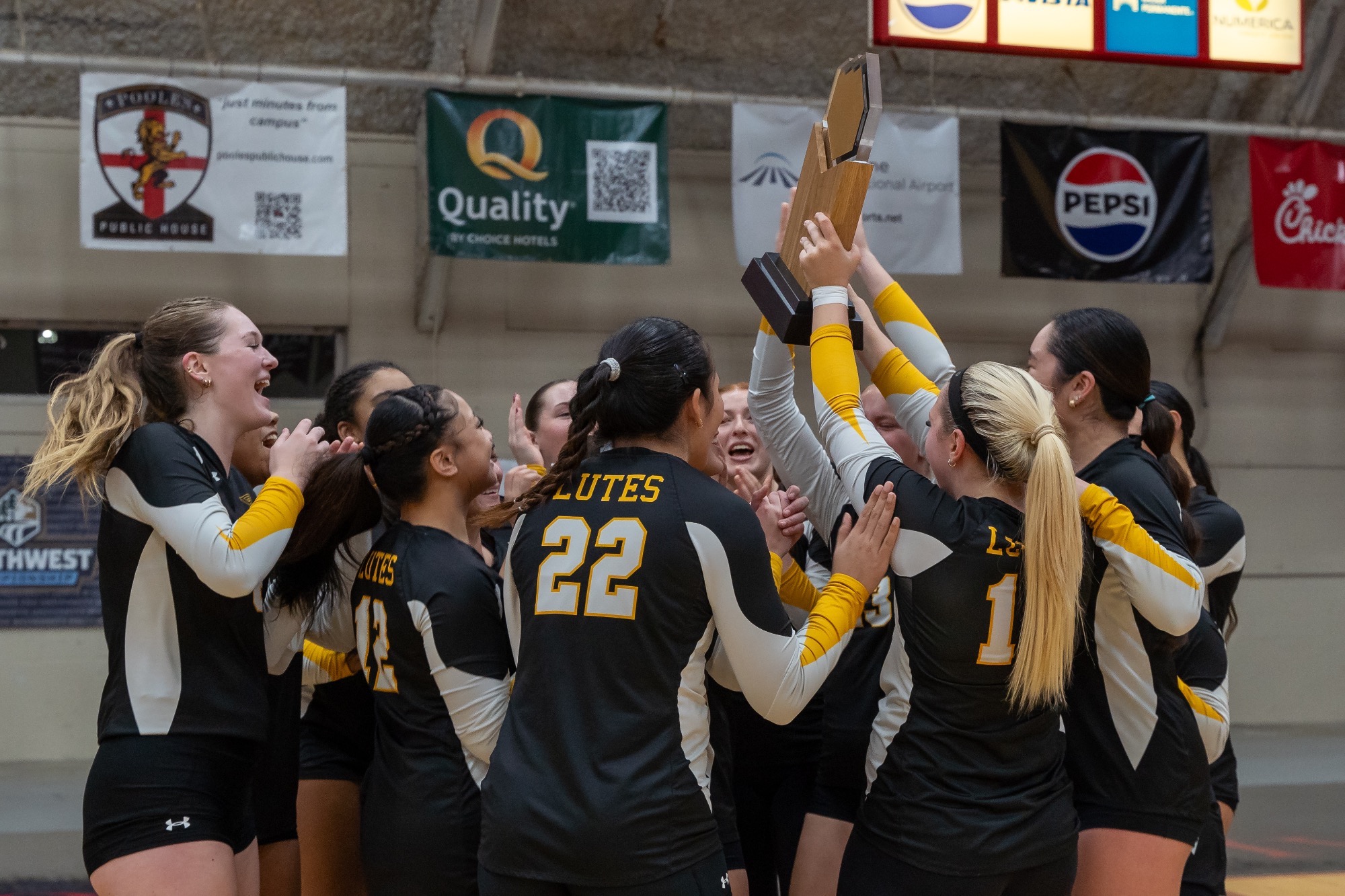 team celebrates winning NWC tournament title