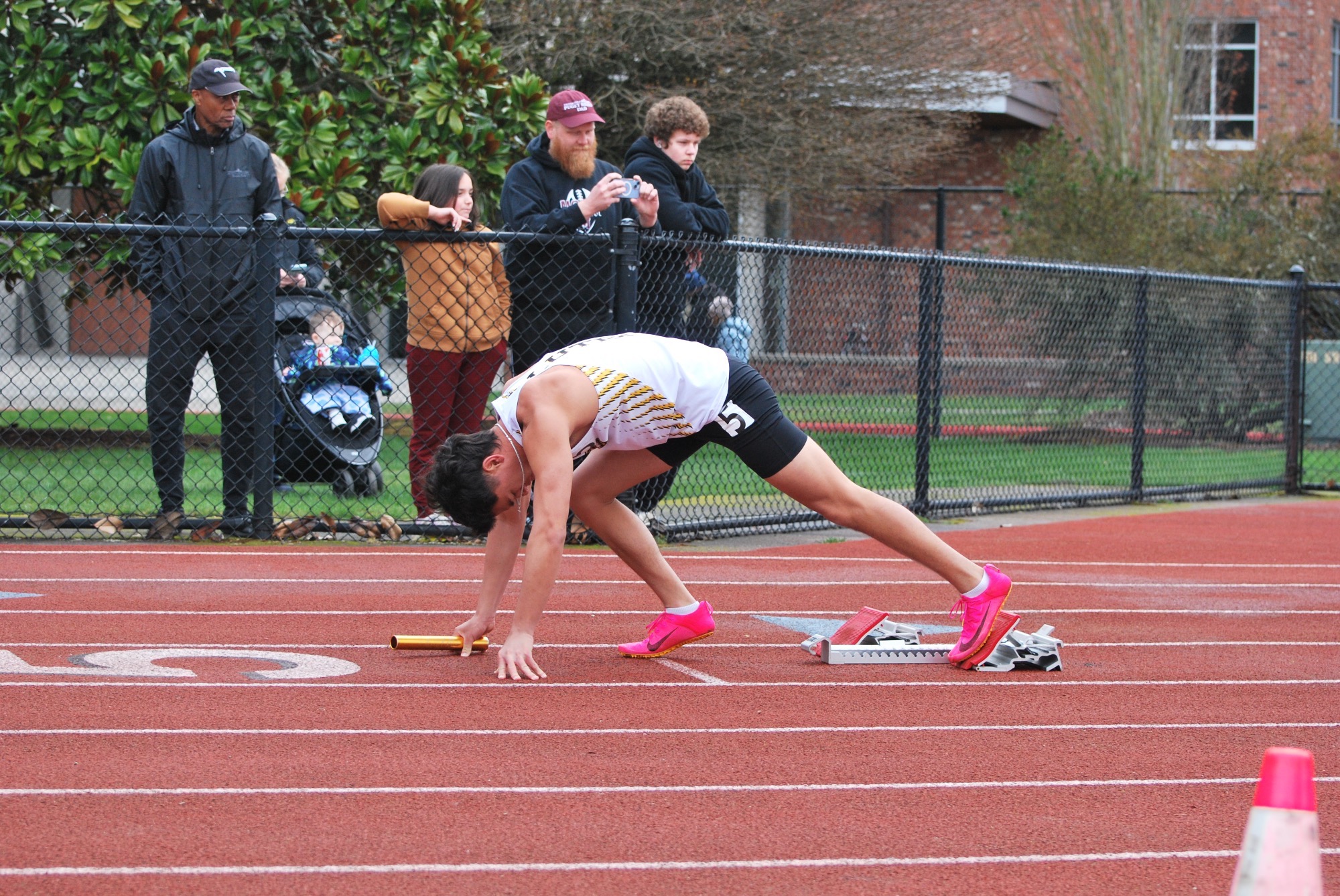 Kaimana Satterfield getting into the blocks for the 4x1 relay at Puget Sound