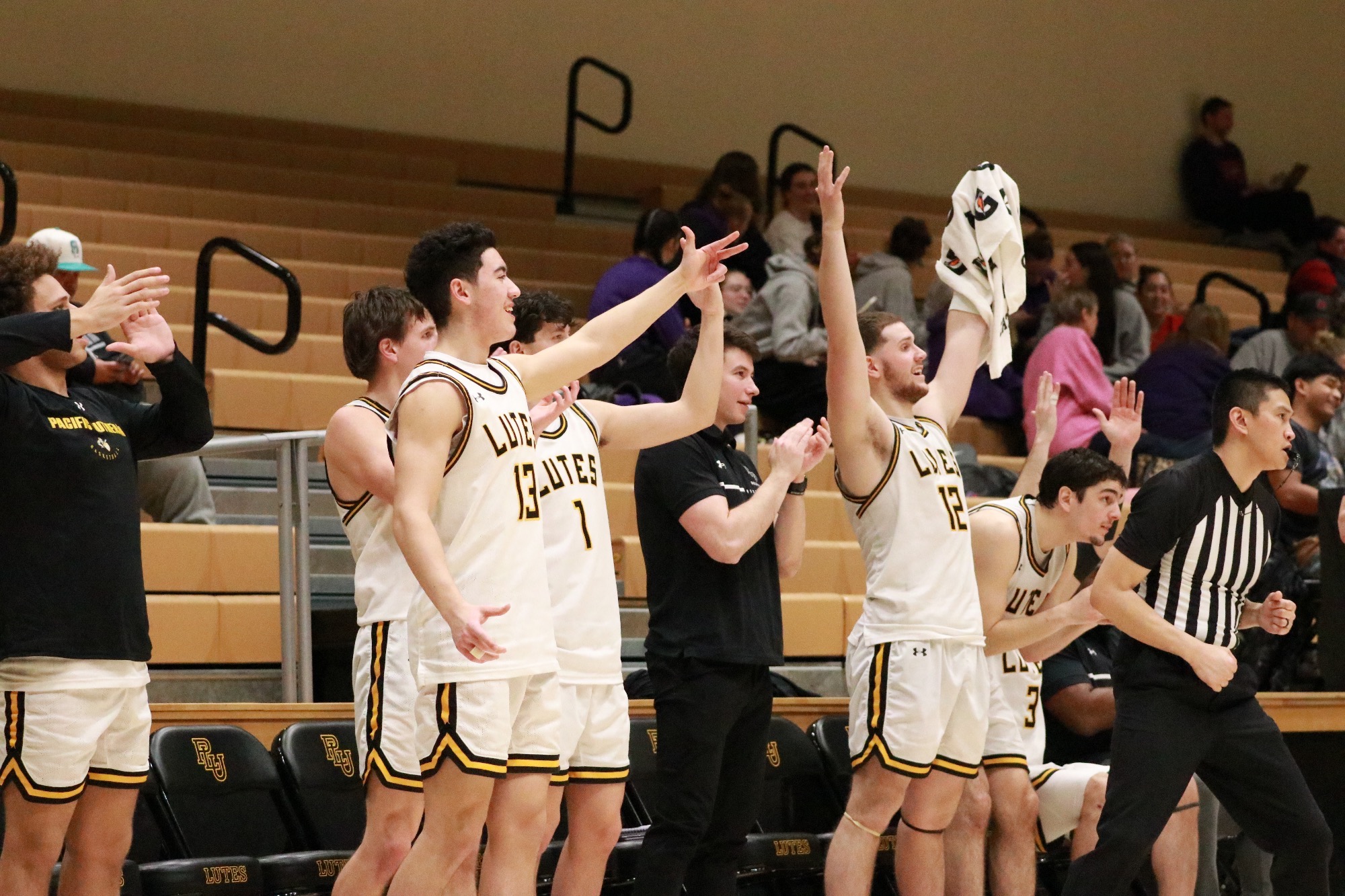 PLU bench mob celebrating in Murray's 100th win at PLU