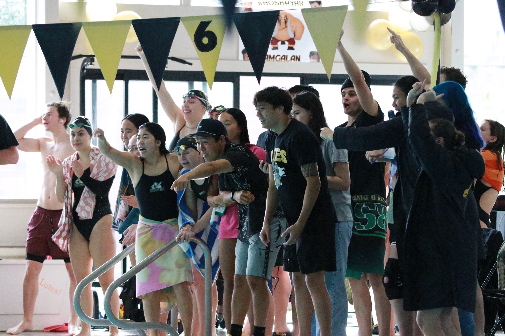Lutes cheering on pool deck in senior day dual meet with Puget Sound