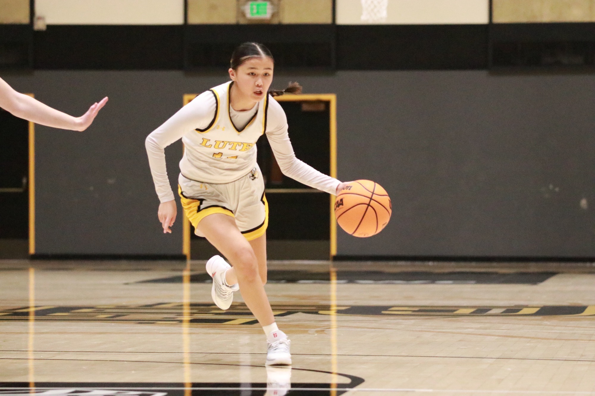 Kristie Kagawa dribbling inside Olson Gym