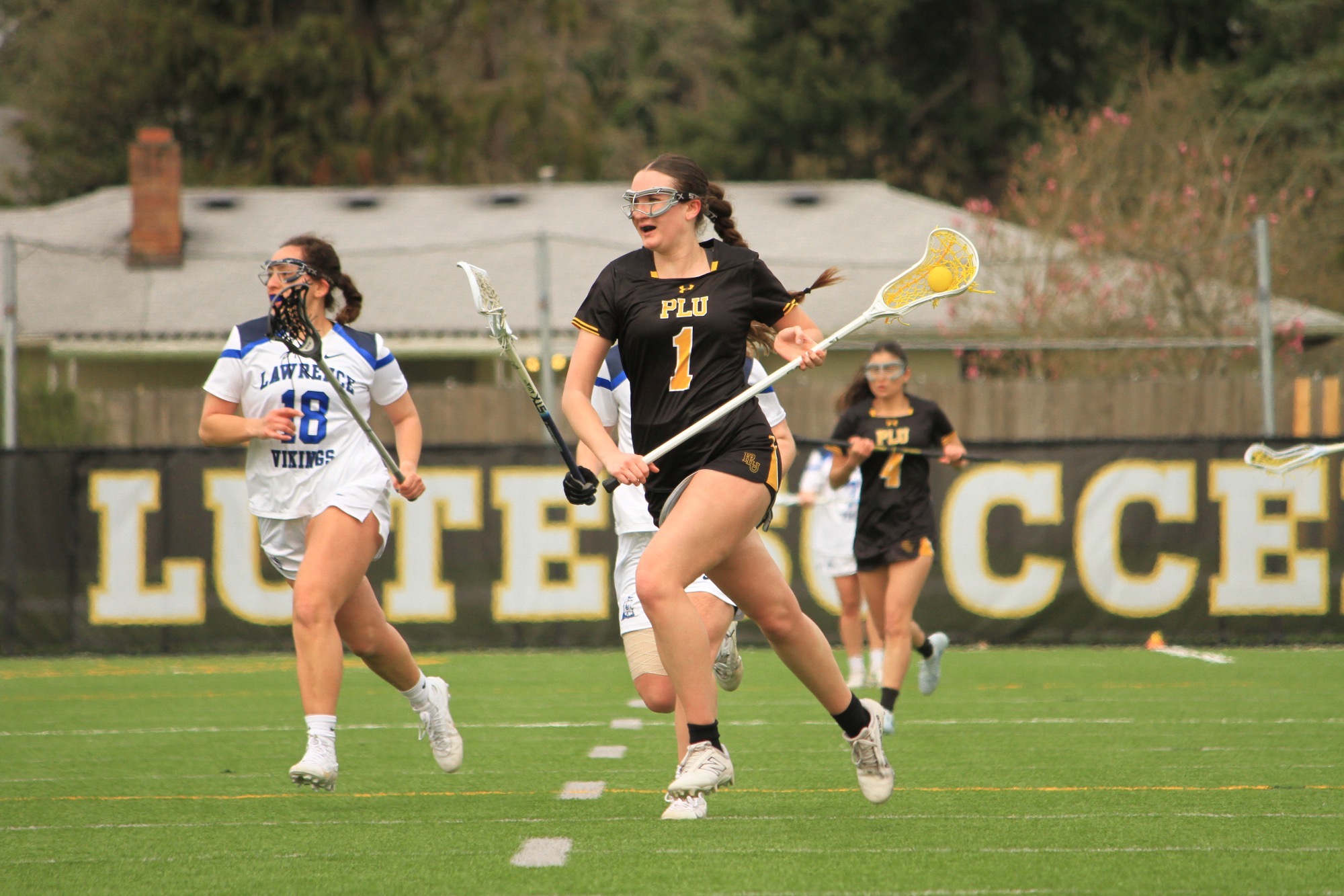 Paige Hackman with the ball against Lawrence U