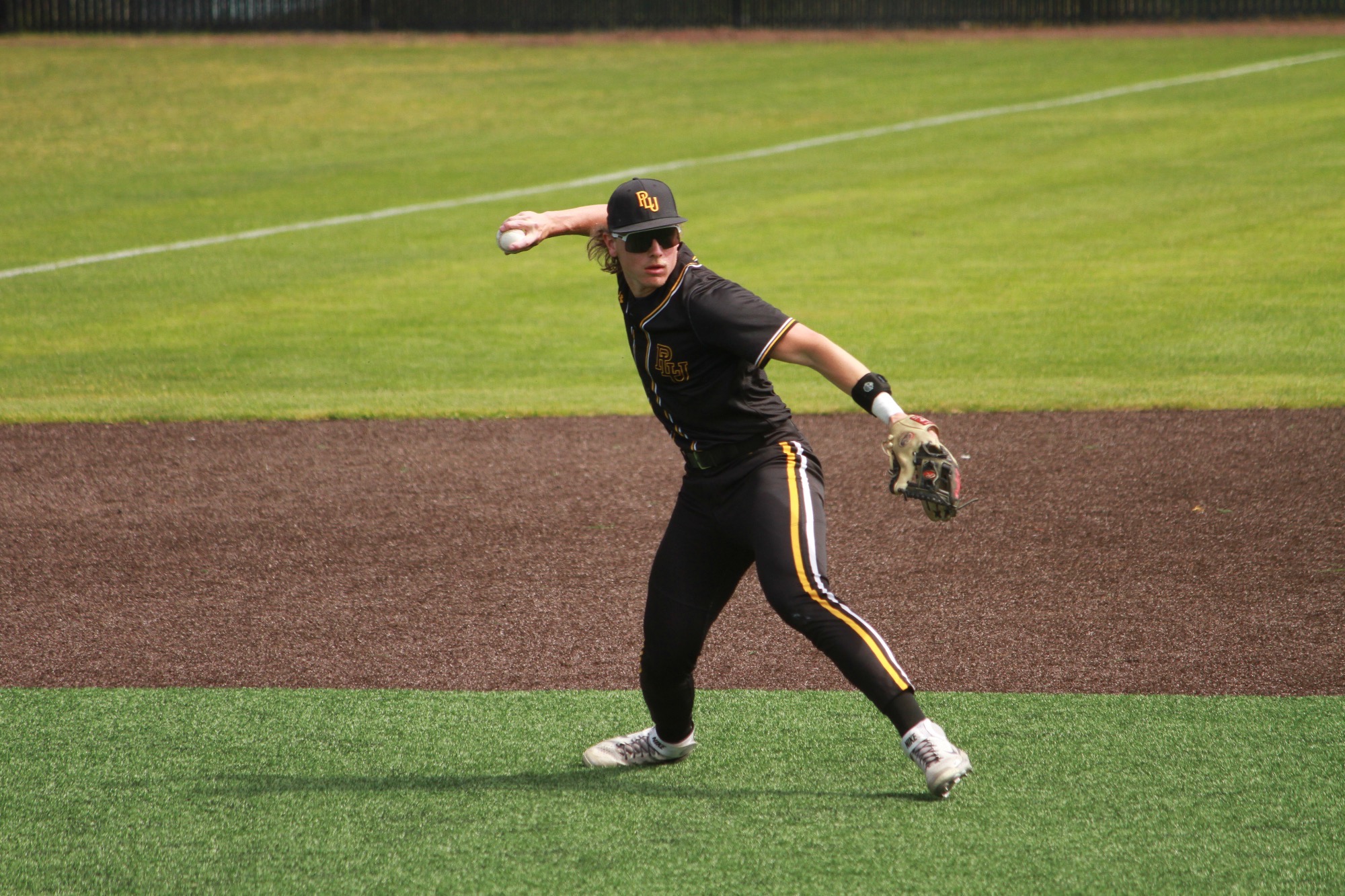Carson Burke fielding a ball at third versus Whitworth