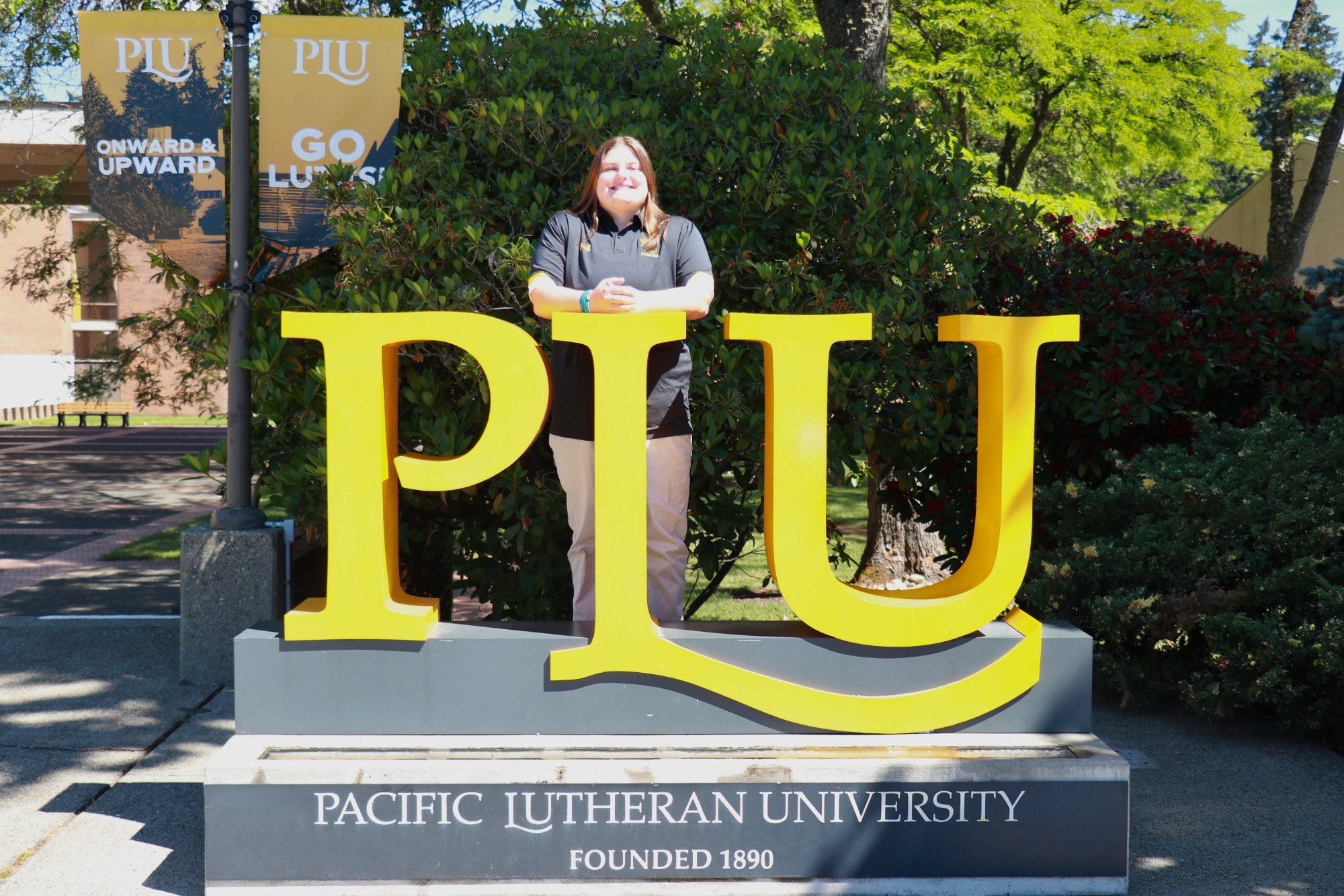 Evelyn Edwards PLU WLAX AC at PLU Monument Sign
