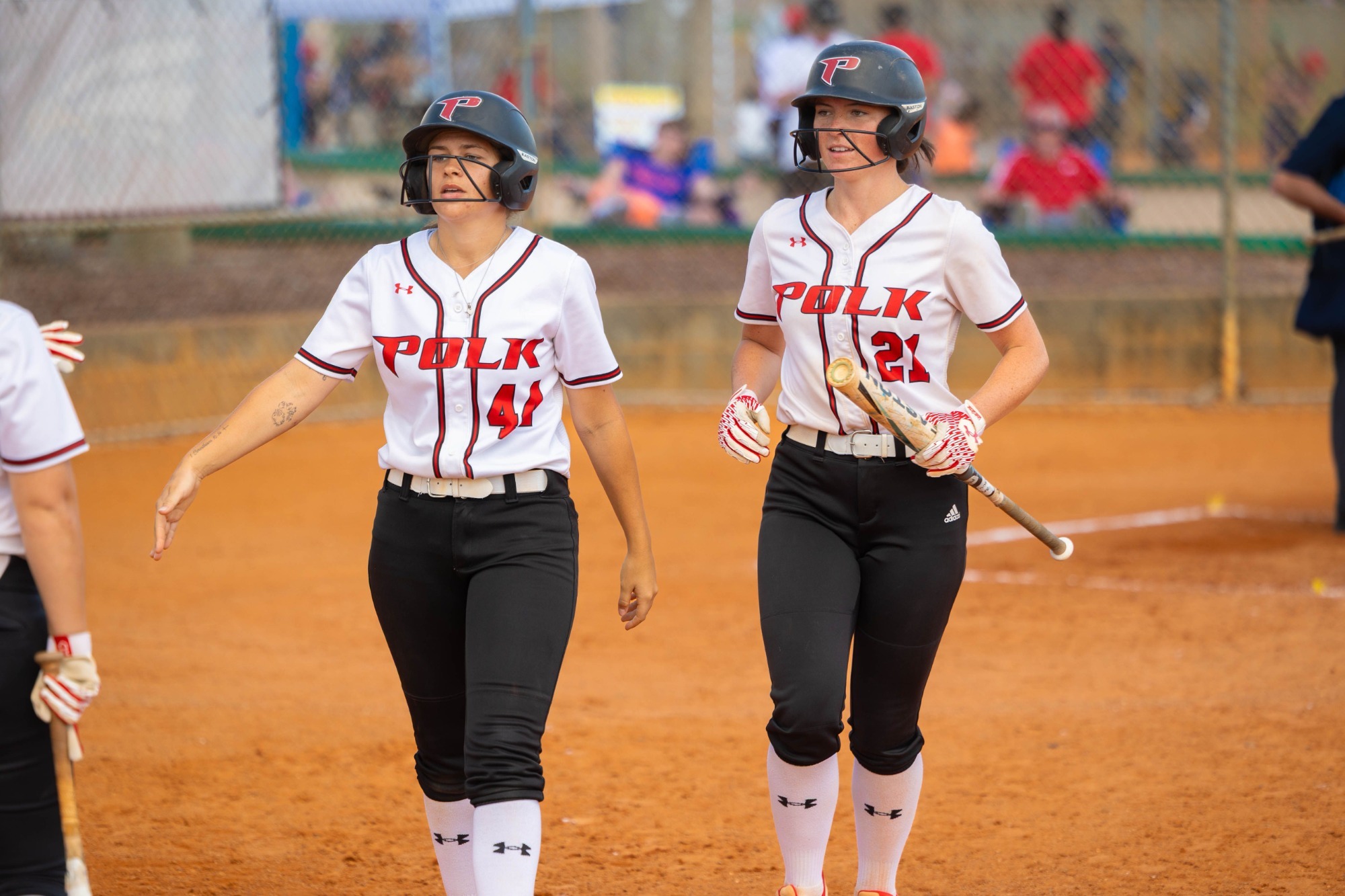 Foster and Hurst head to the dugout after scoring runs