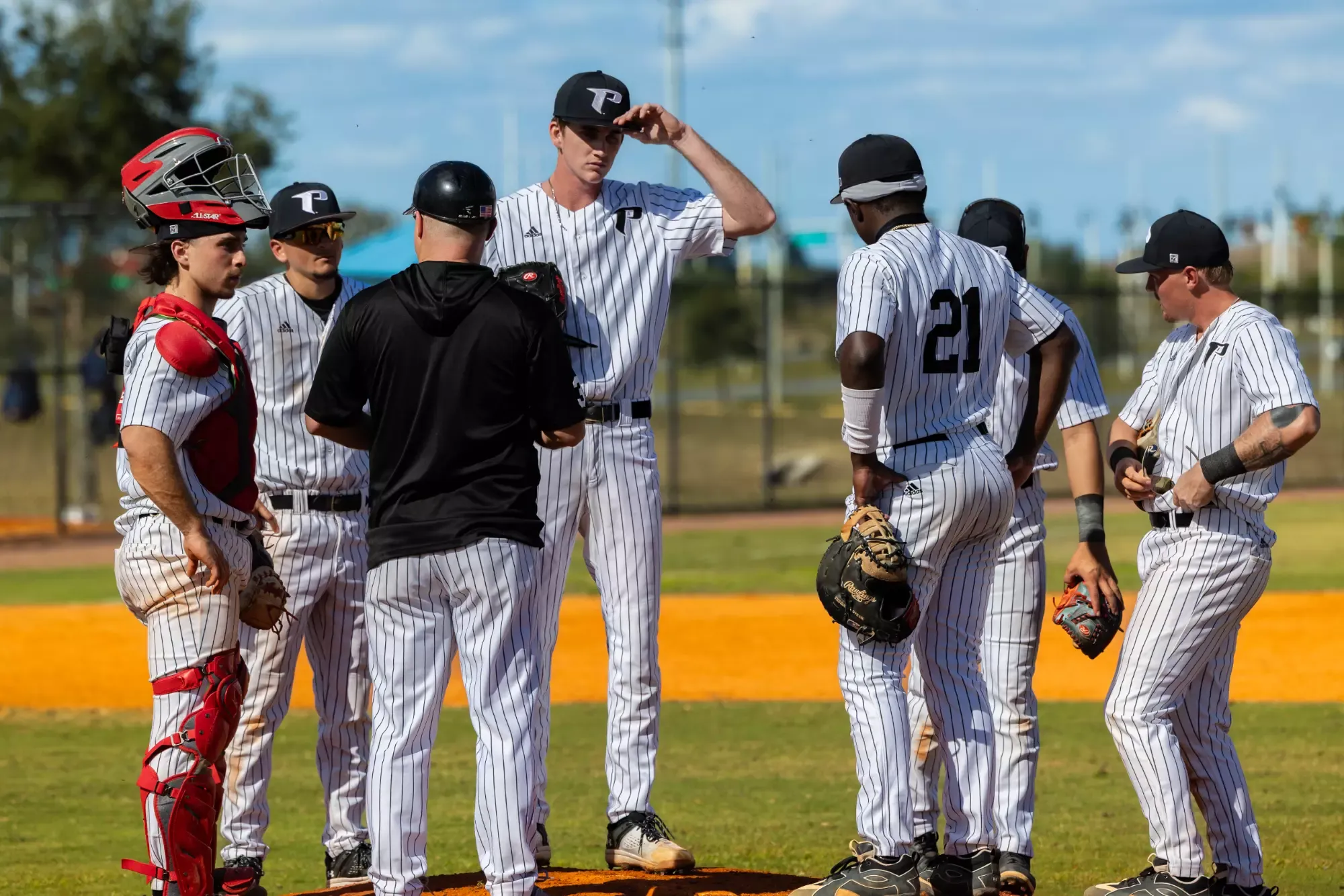 Coach Abrams calls a meeting on the mound