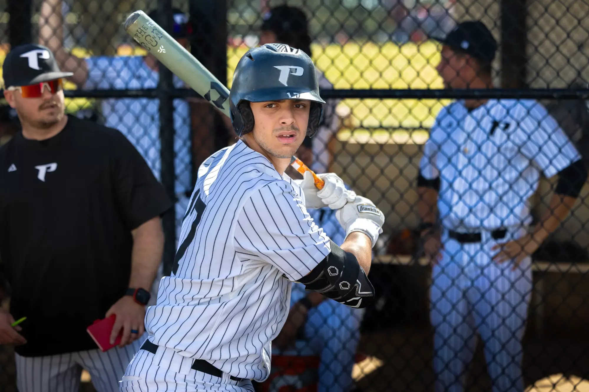 Brunet warms up in the on-deck circle