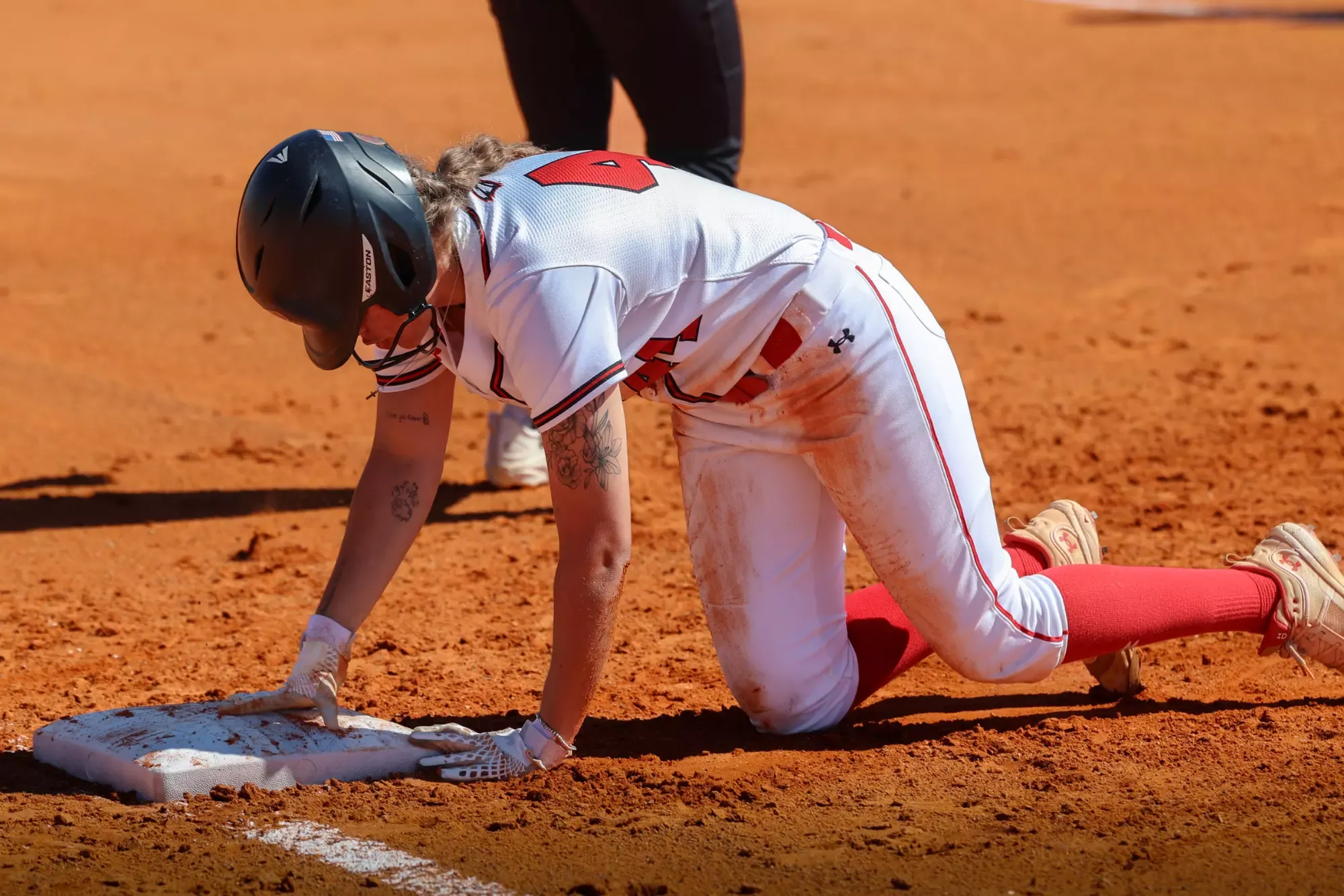 Foster dives back in to first base