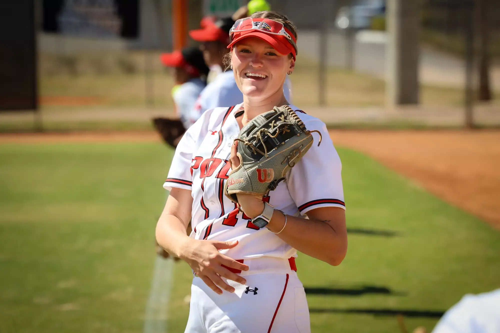 Emma Kaylor warms up her teammates in between innings