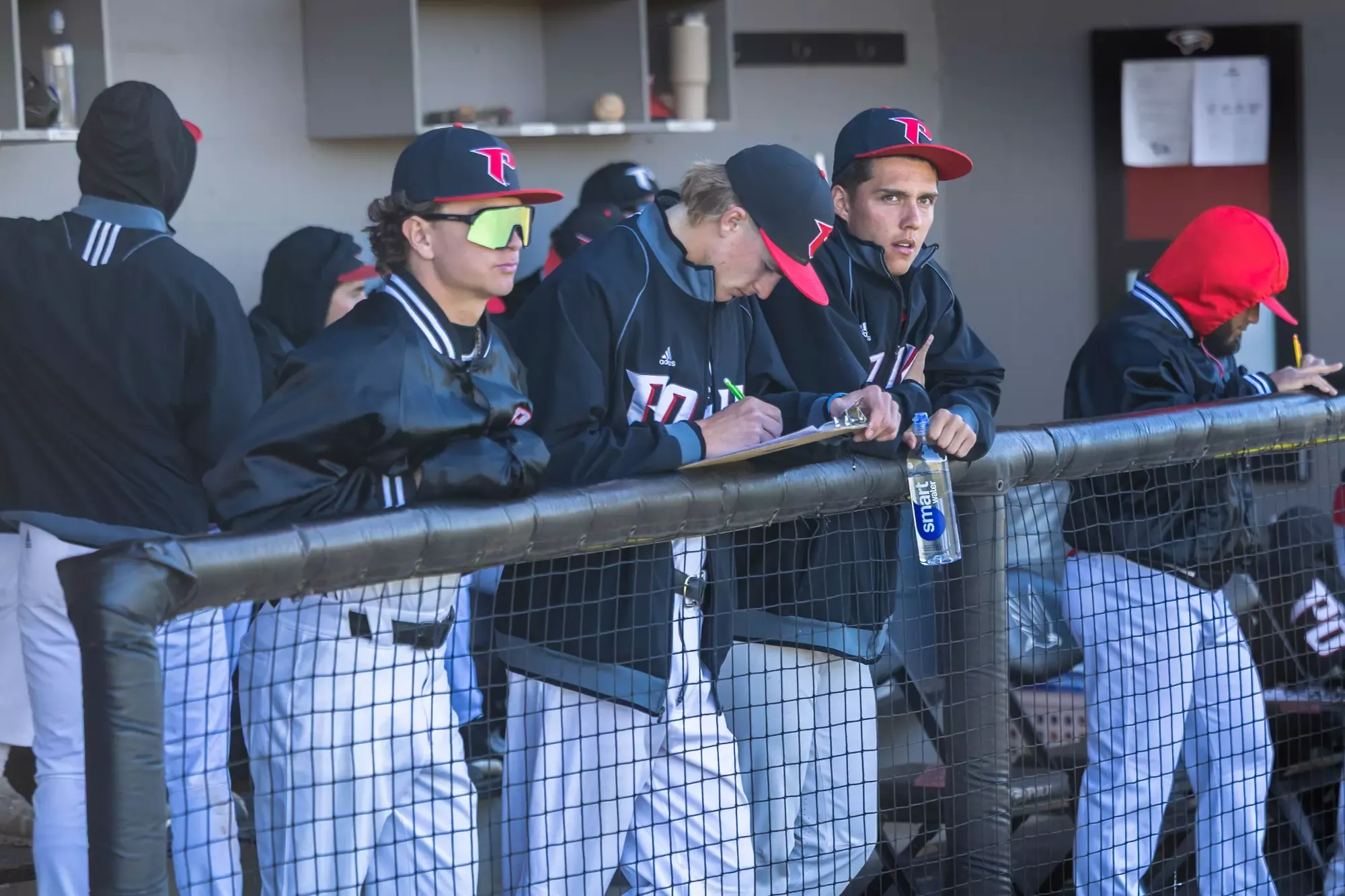 Tibbetts, Schatz and Maynard look on from the dugout