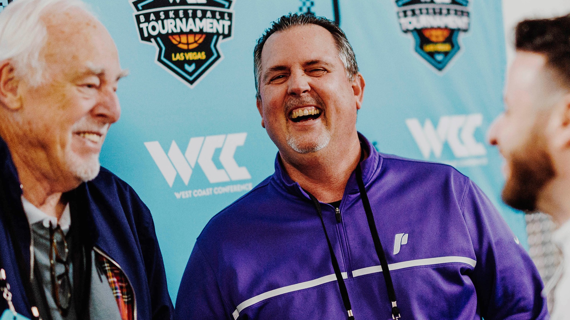 Scott Leykam laughs with colleagues at the 2023 WCC Basketball Tournament