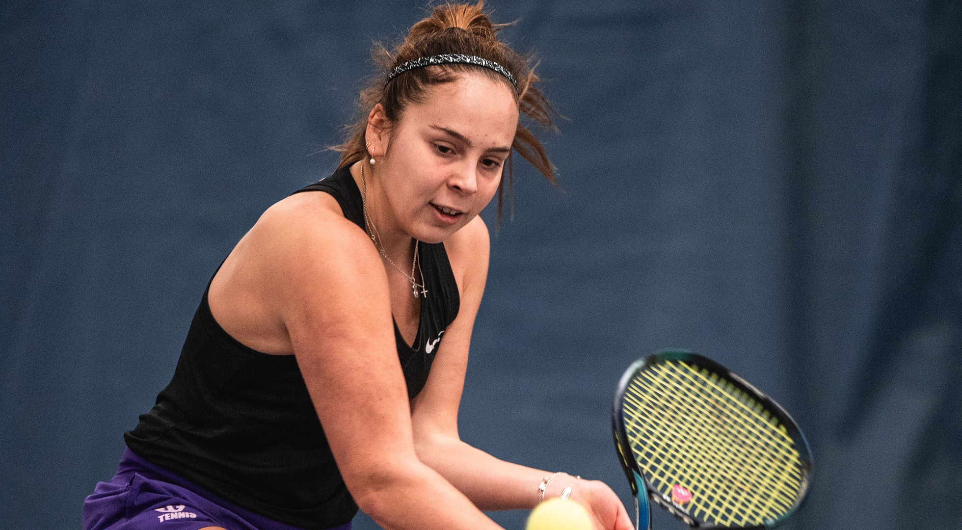 Alaia Rubio Perez hits a backhand during singles play.