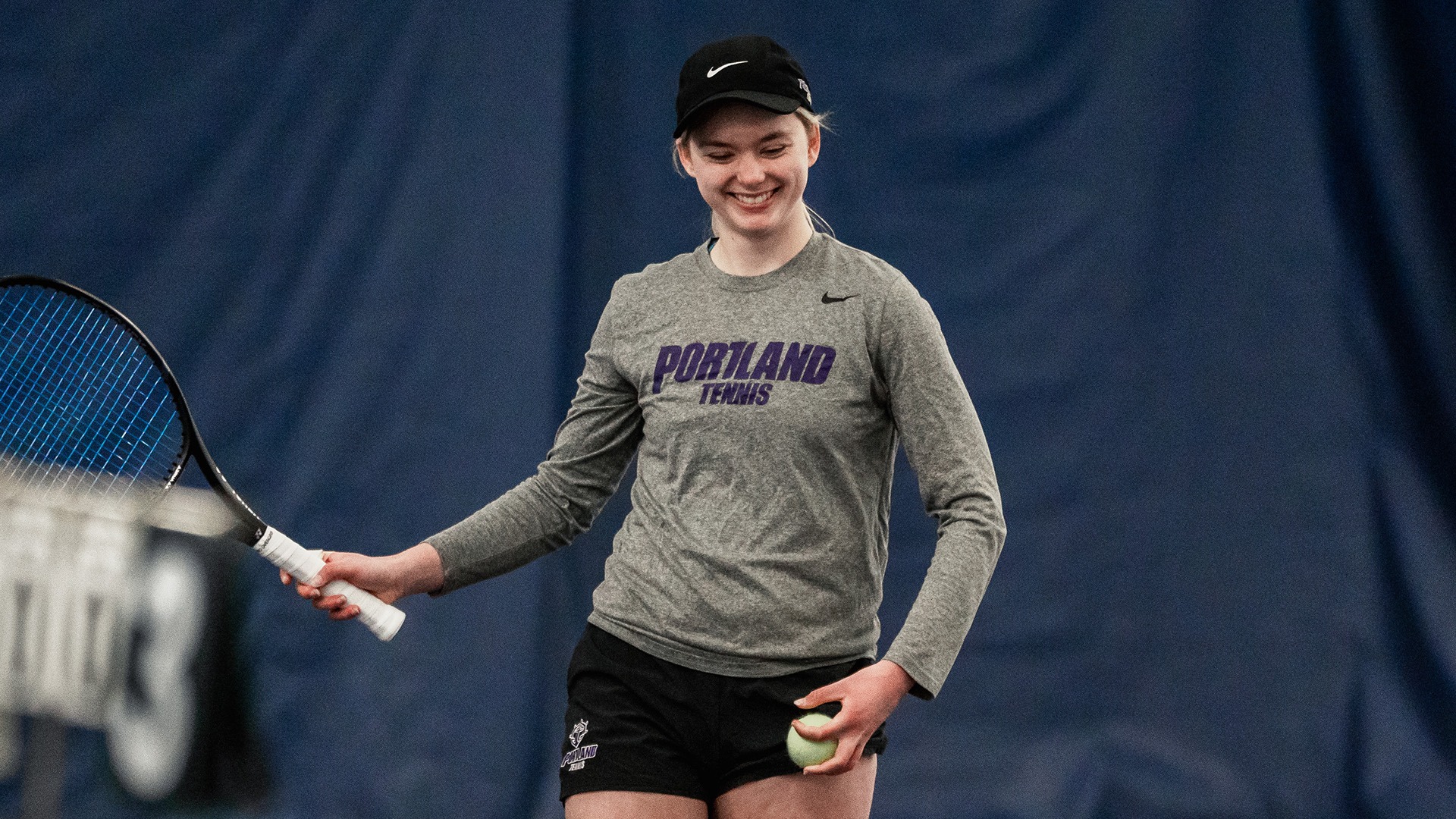Meagan Pearson smiles between points during a home doubles match vs. Portland State.