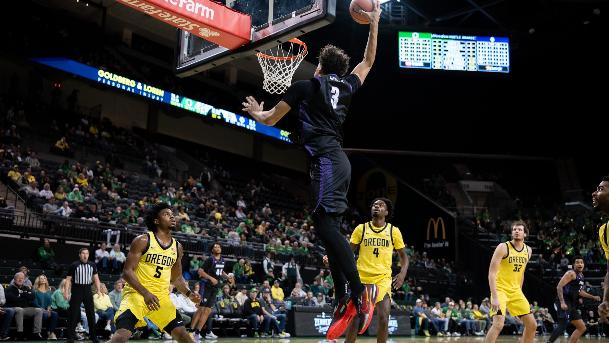 Timo George dunks in a road game at Oregon on Dec. 17, 2025
