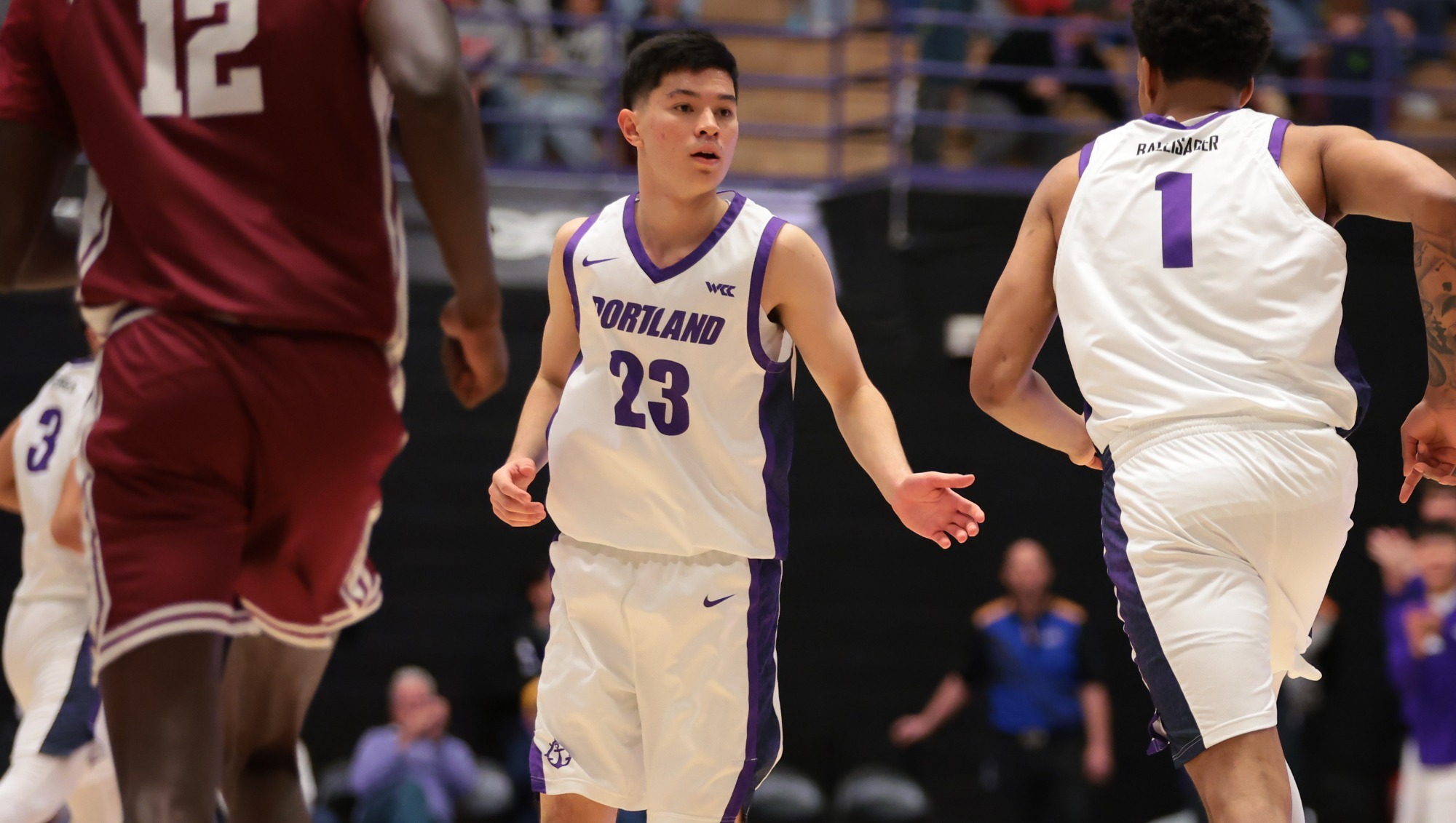Joel Foxwell high fives a teammate during a home game against Santa-Clara.