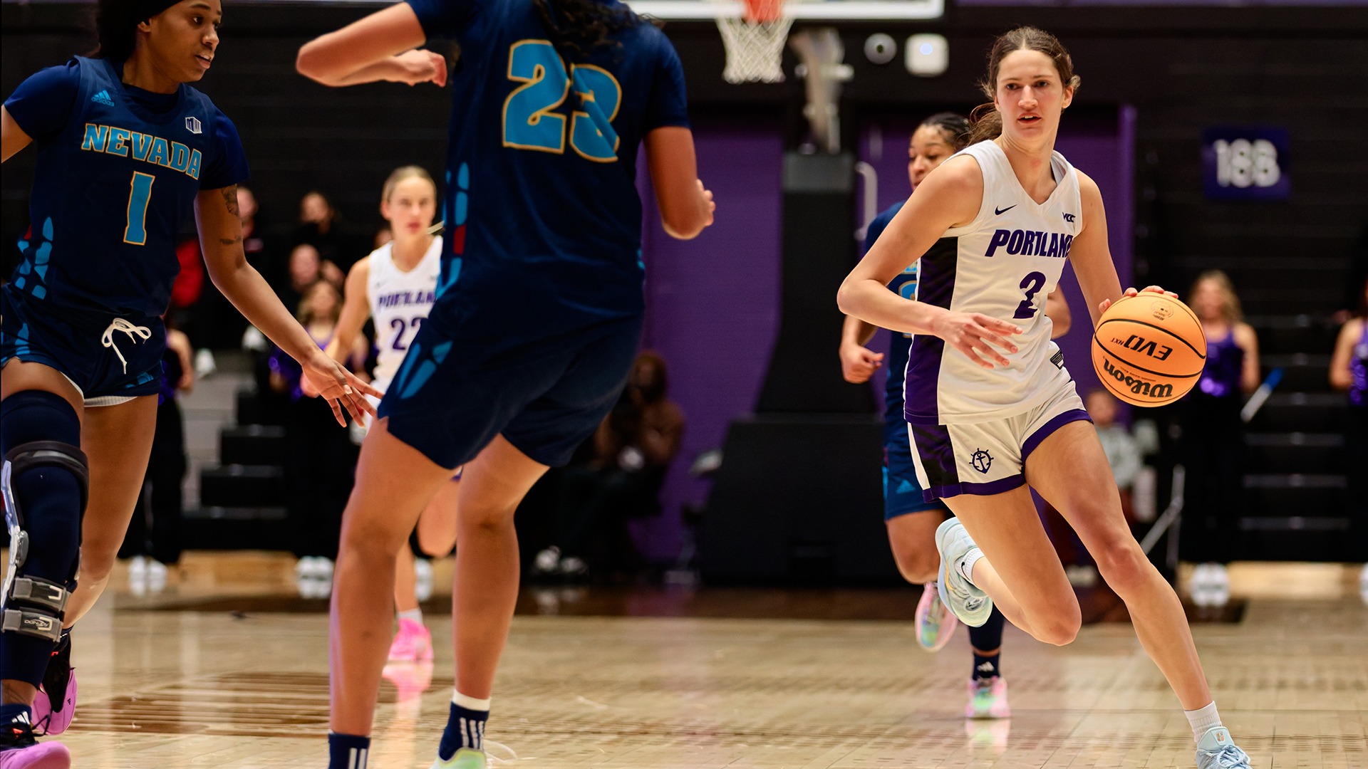 Dyani Ananiev drives by her defenders against Nevada.