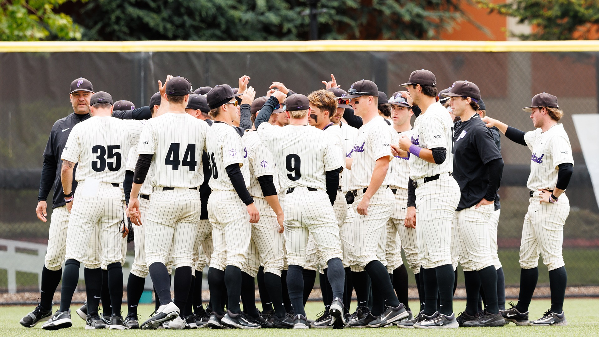 The Pilots huddle postgame in the outfield.
