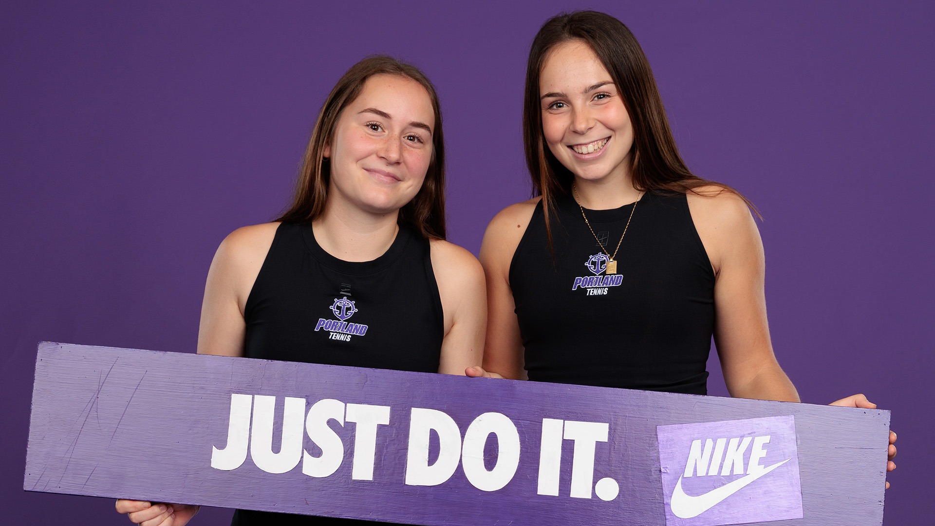 Maria Galatescu and Alaia Rubio Perez pose with a nike sign at media day.