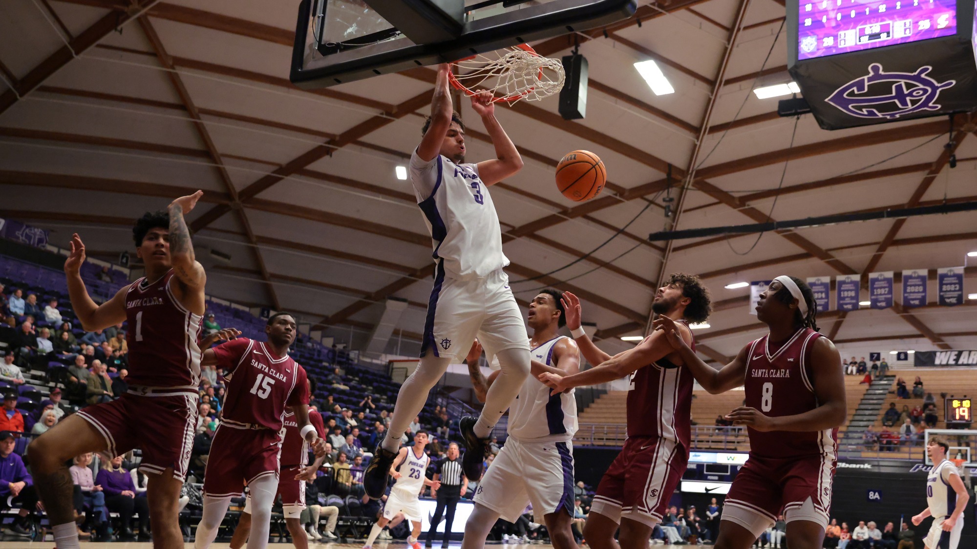 Timo George dunks in a home game against Santa-Clara.