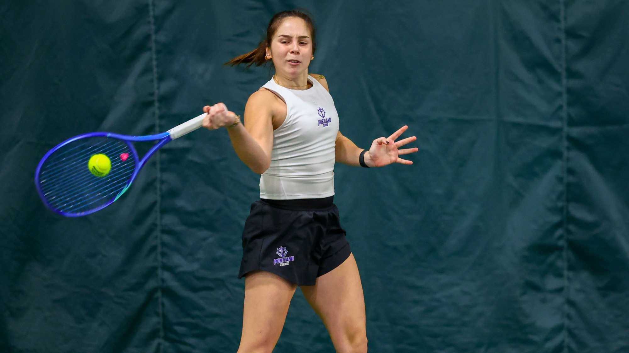 Alaia Rubio Perez hits a forehand in a road match at Stonehill College.