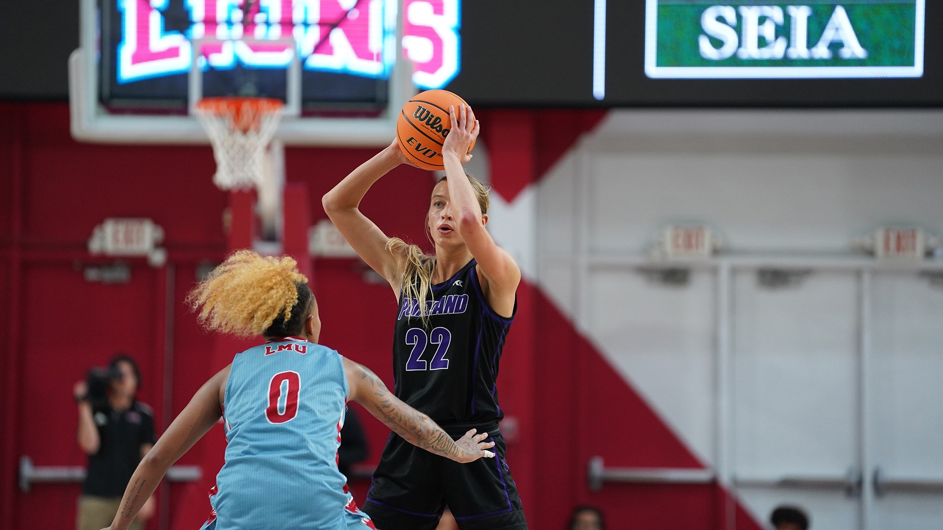 Rhyan Mogel scans the court for an open pass. against LMU.