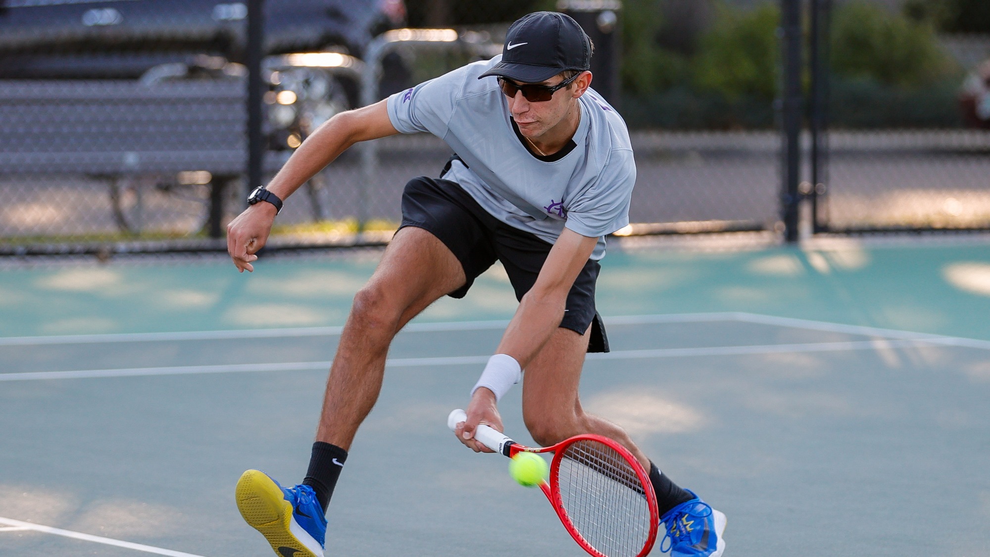 Eli Noel hits a volley at the net.
