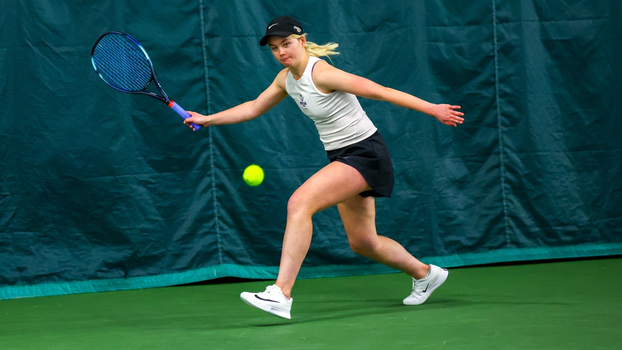 Meagan Pearson hits a slice forehand during a singles match.