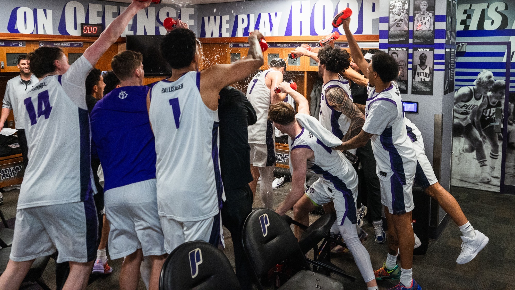 Matus Hronsky is doused with water in the locker room following his game-winning three against Pacific at Chiles Center.