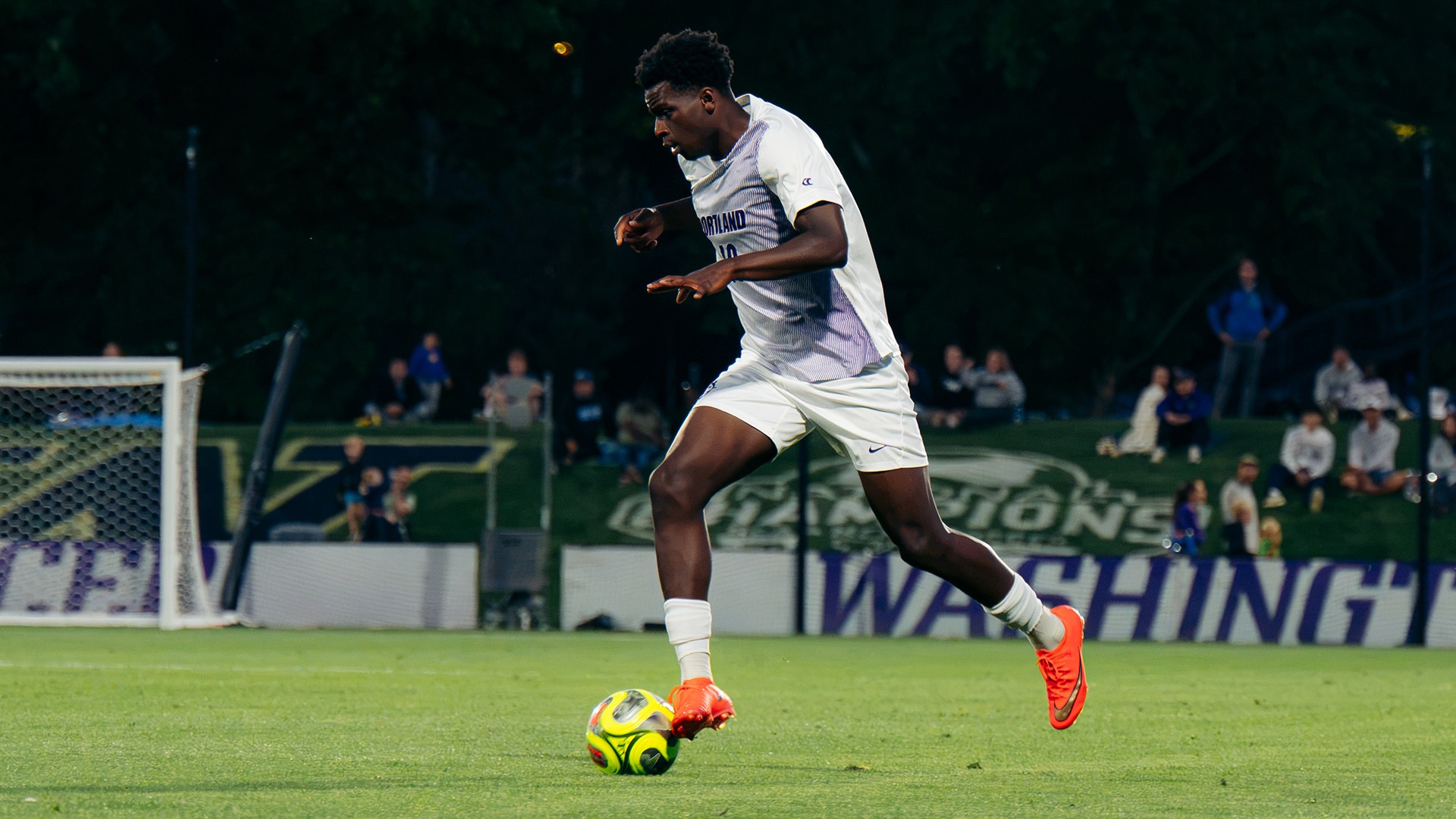 David Ajagbe takes the ball downfield against the Huskies.