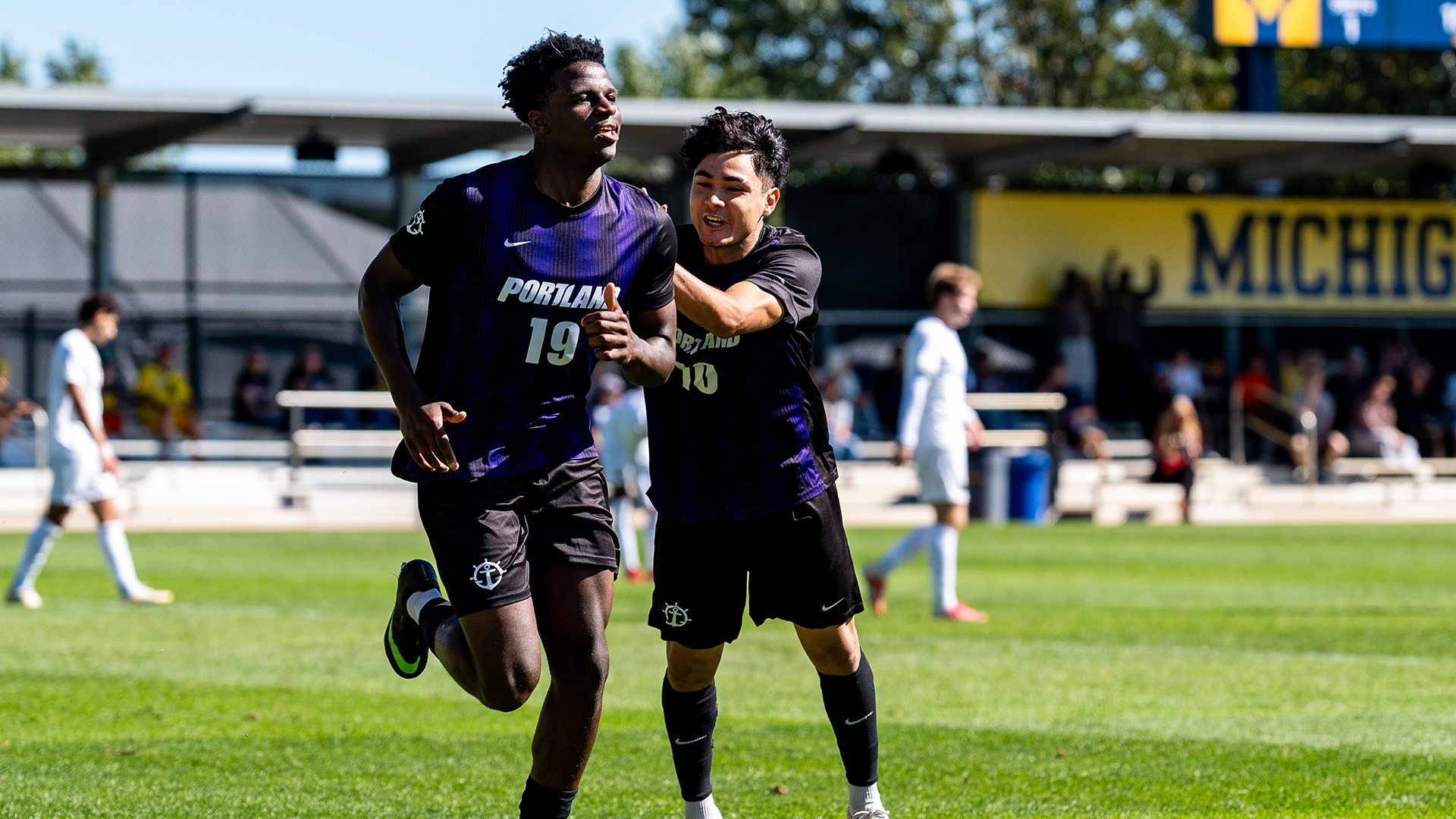 David Ajagbe and Diego Rosas celebrate Ajagbe's goal.