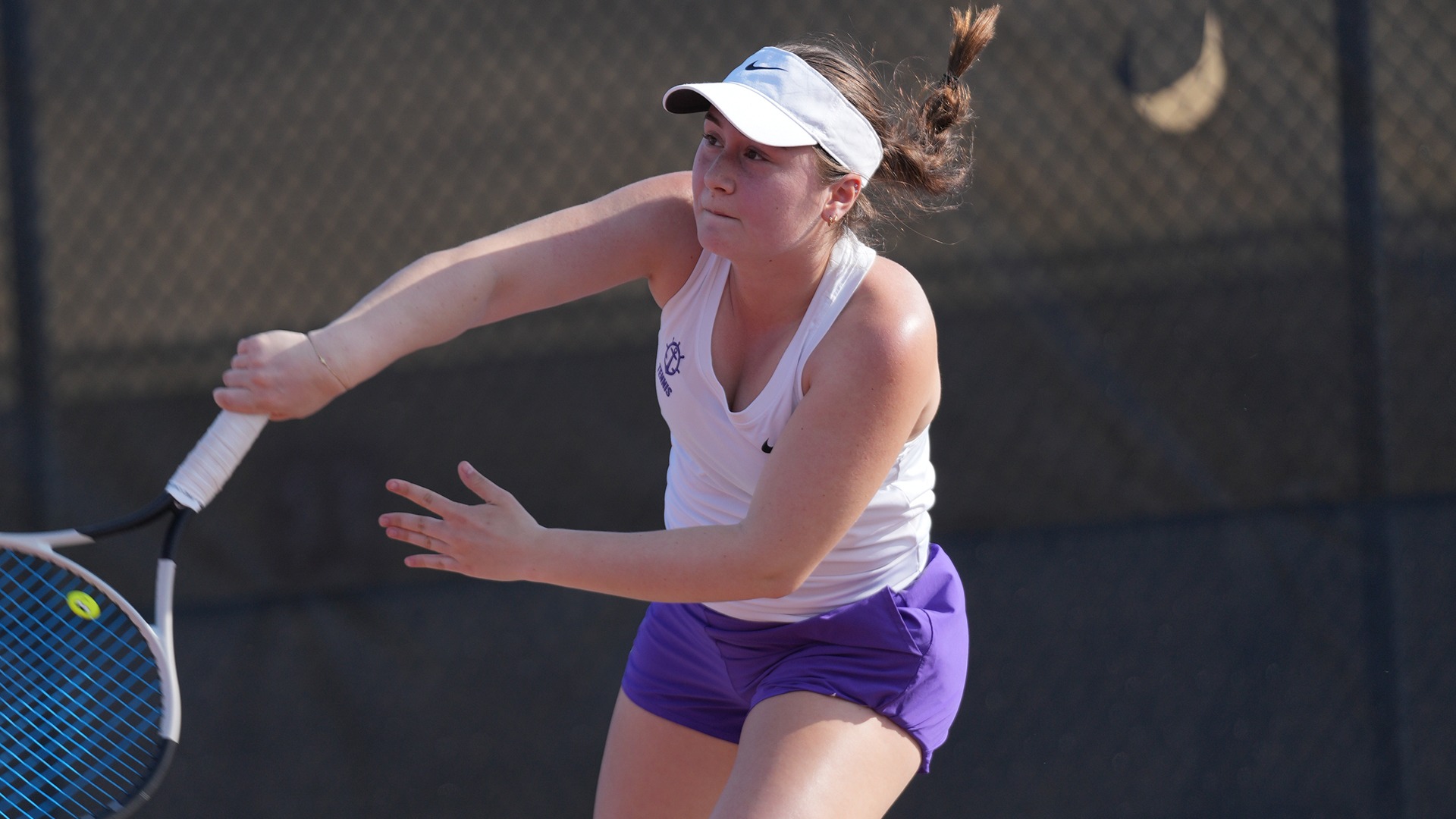 Maria Galatescu hits a serve during a singles match in the fall season.
