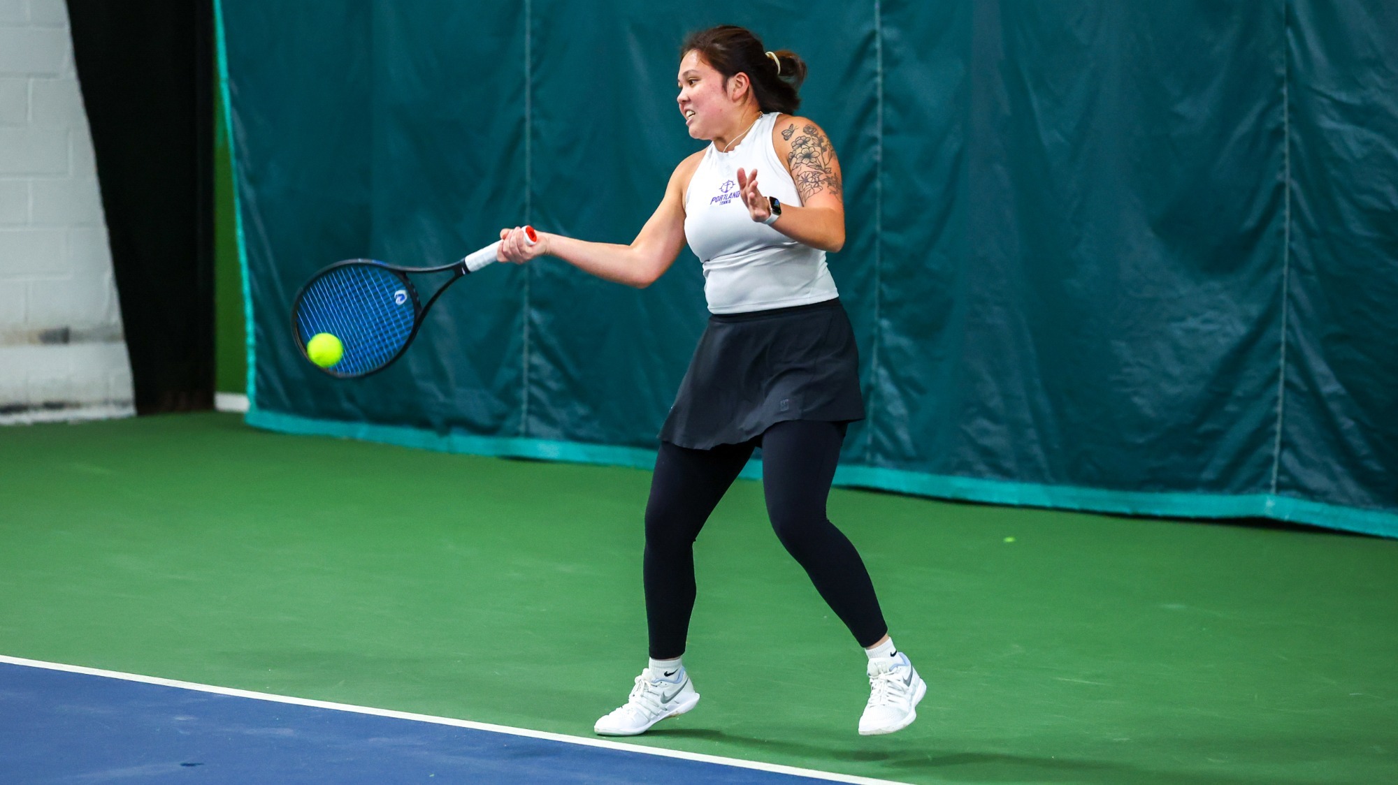 Kylie Canubida hits a forehand.