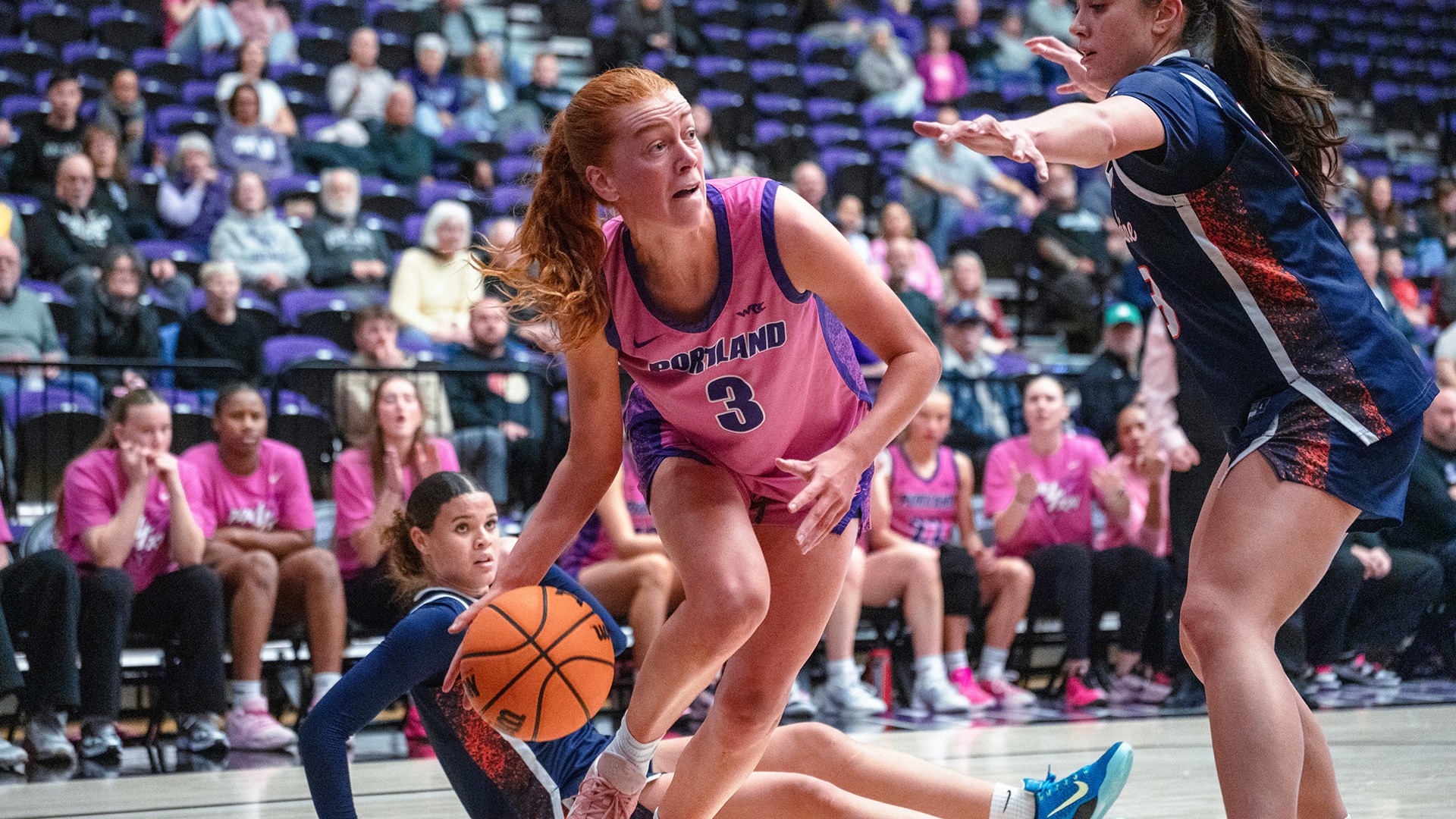 Florence Dallow looks for the pass on the baseline.