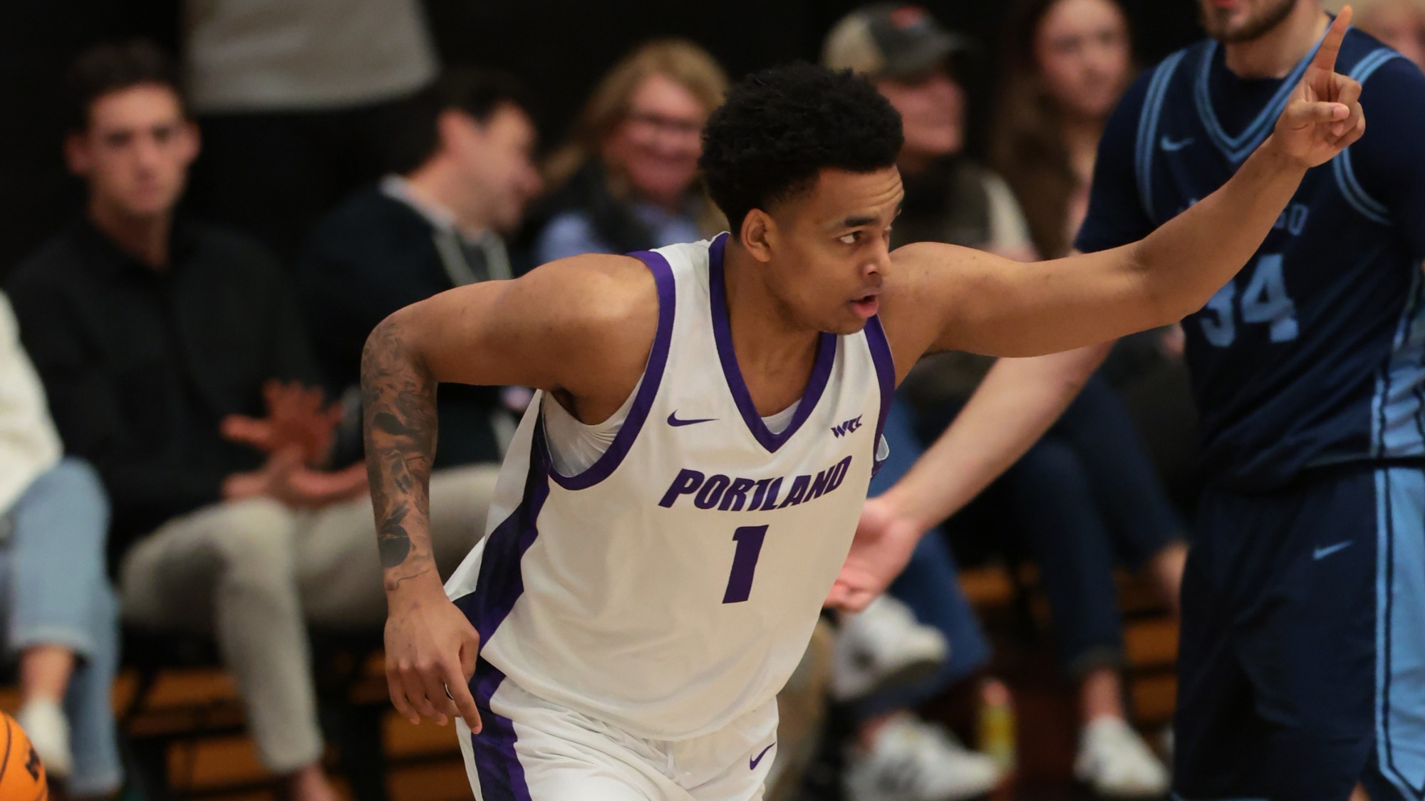 Jermaine Ballisager Webb points to a teammate after making a basket versus San Diego at Chiles Center.