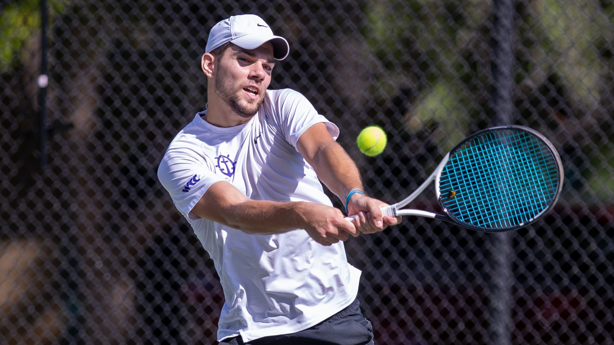 Nikola Keremedchiev hits a backhand during a singles match.