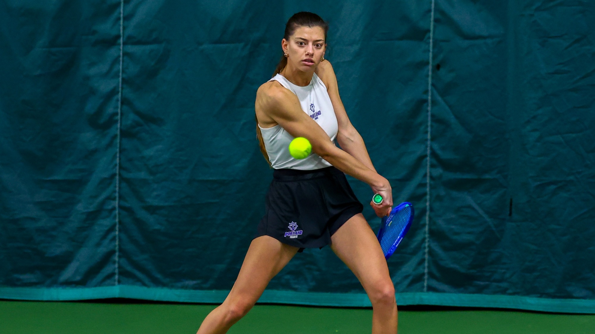 Dariya Radulova hits a backhand during a dual singles match.
