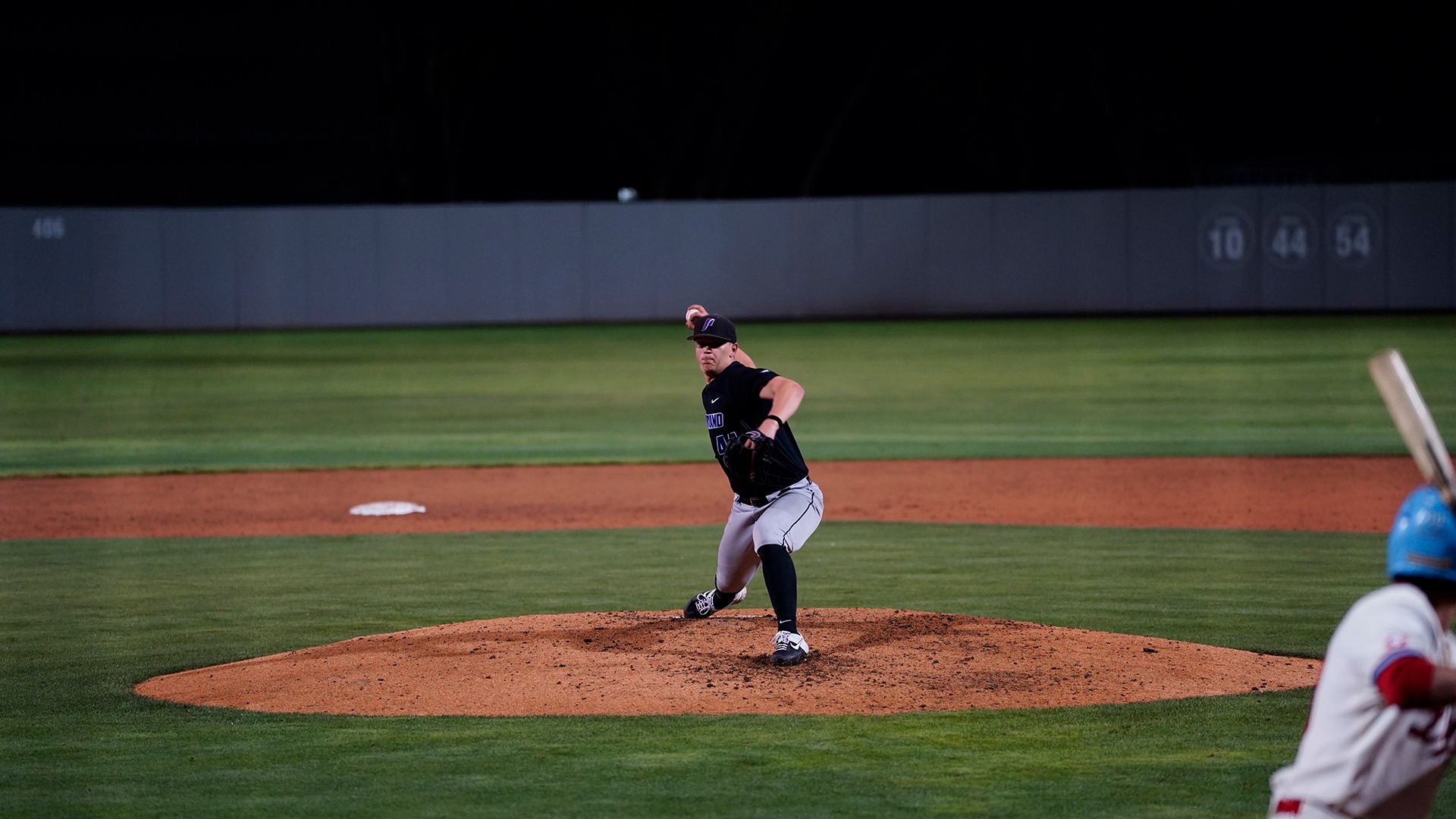 Trey Swygart delivers the pitch against an LMU batter.