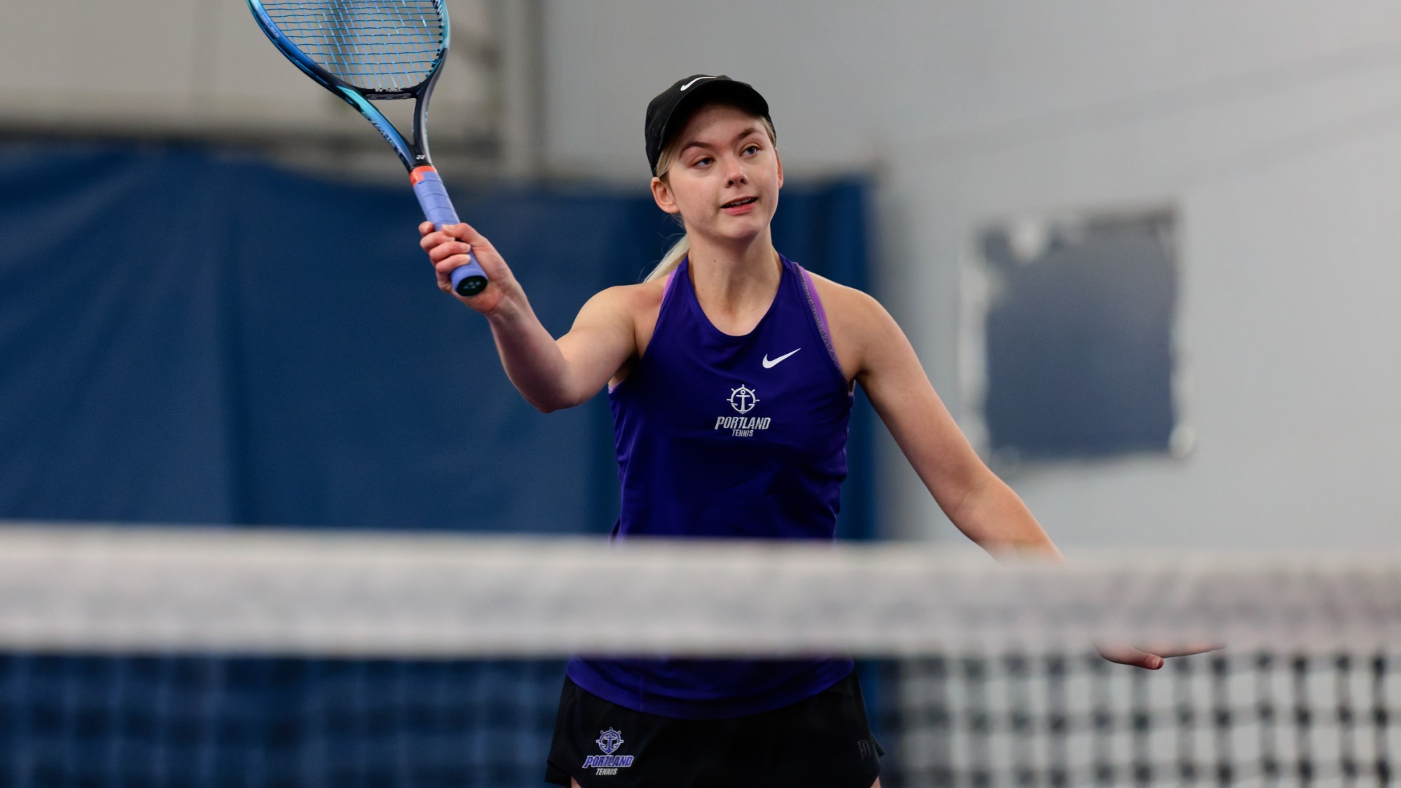 Meagan Pearson hits a volley at the net in a dual match.