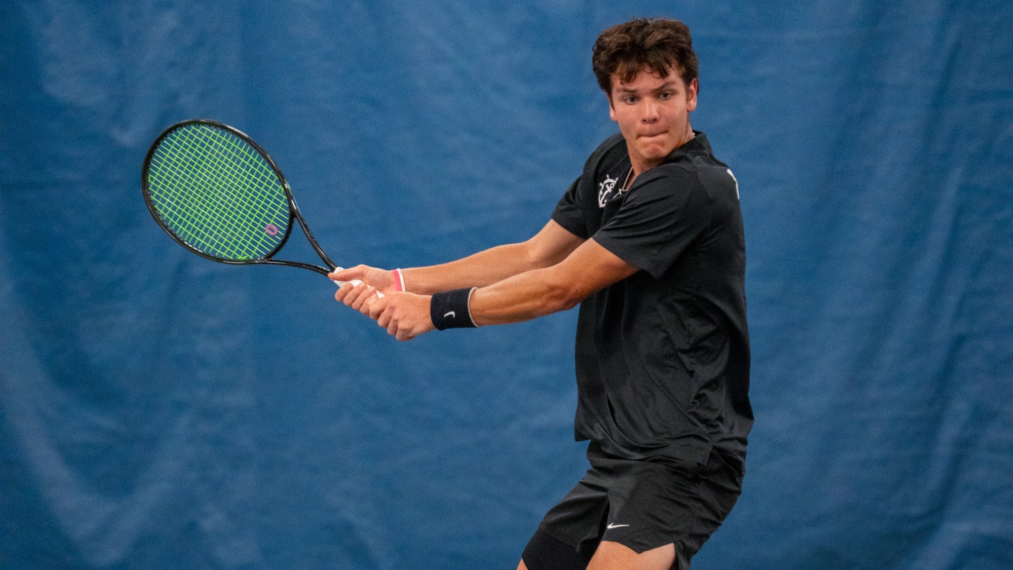 Cade Fernando prepares to hit a backhand during a home dual match vs. Santa Clara.