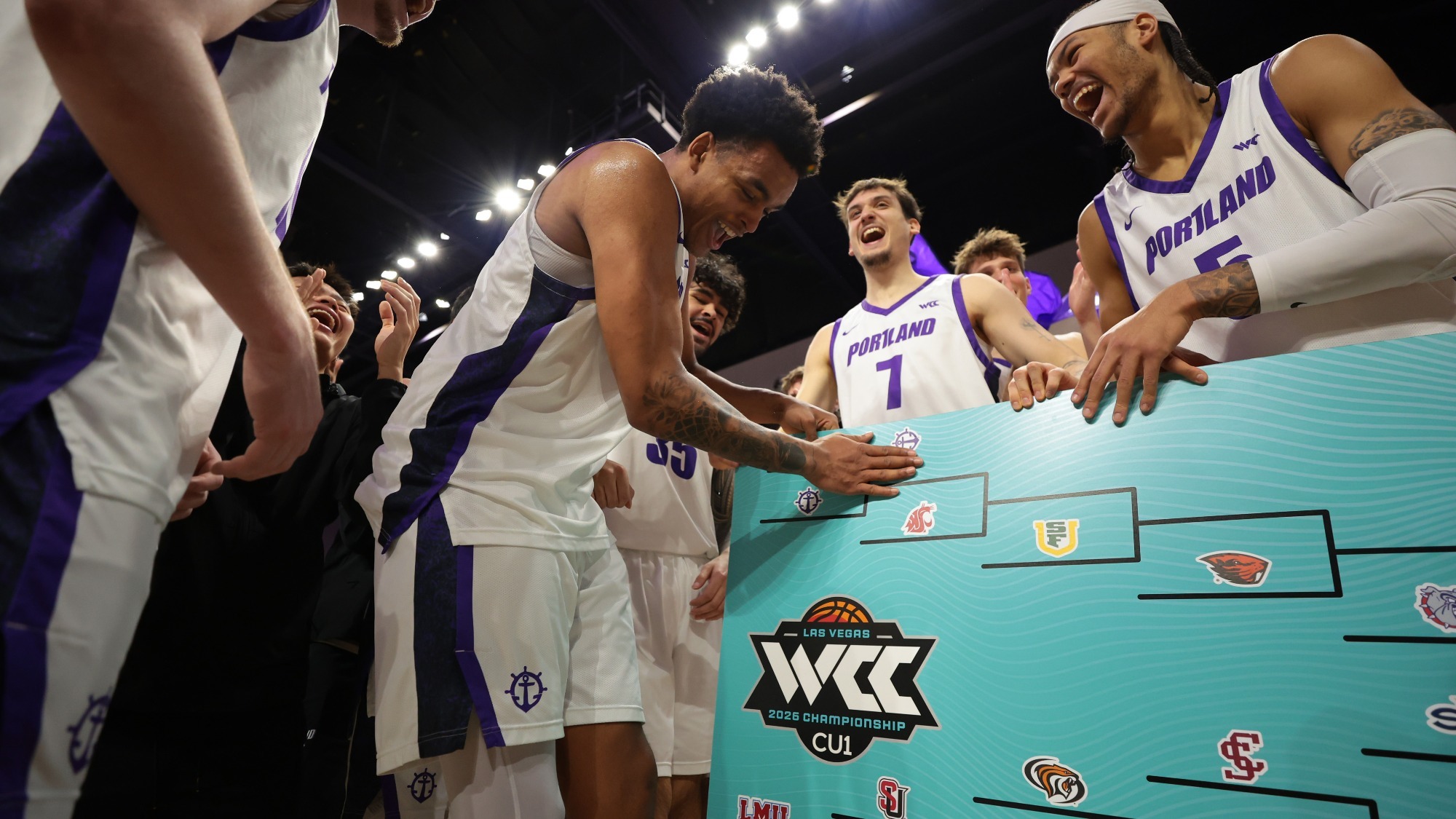 Jermaine Ballisager Webb celebrates with teammates after defeating Pepperdine at the WCC Tournament.
