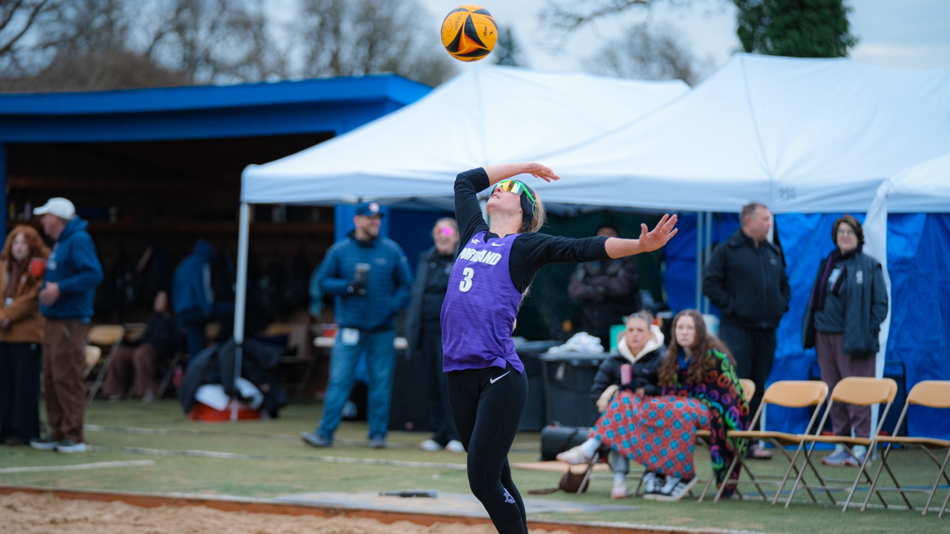 Tate Mercer serving the ball