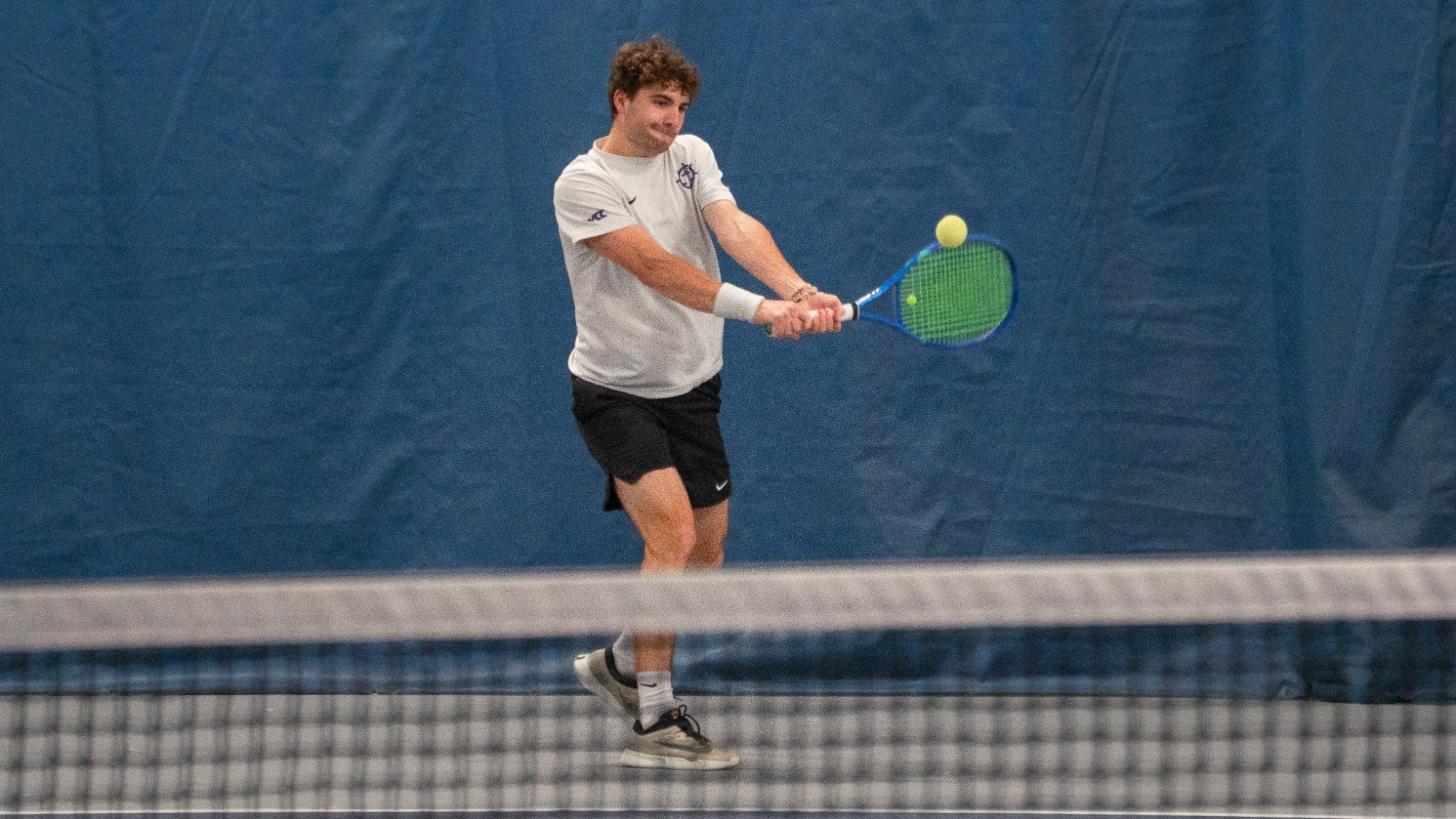 Tom Garcia hits a backhand during a home match versus Saint Mary's.