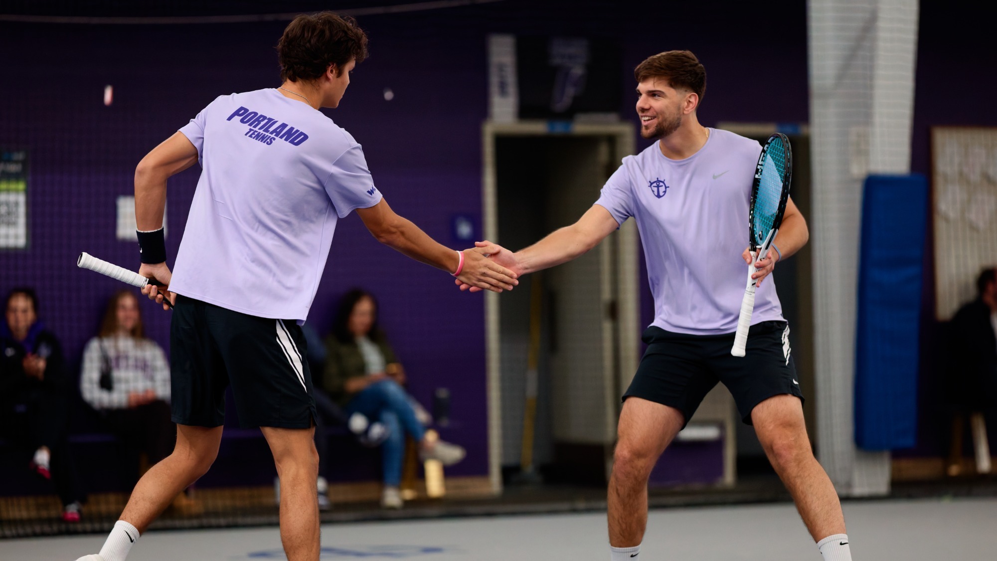 Nikola Keremedchiev and Cade Fernando celebrate a doubles point won in a home match vs. Gonzaga.