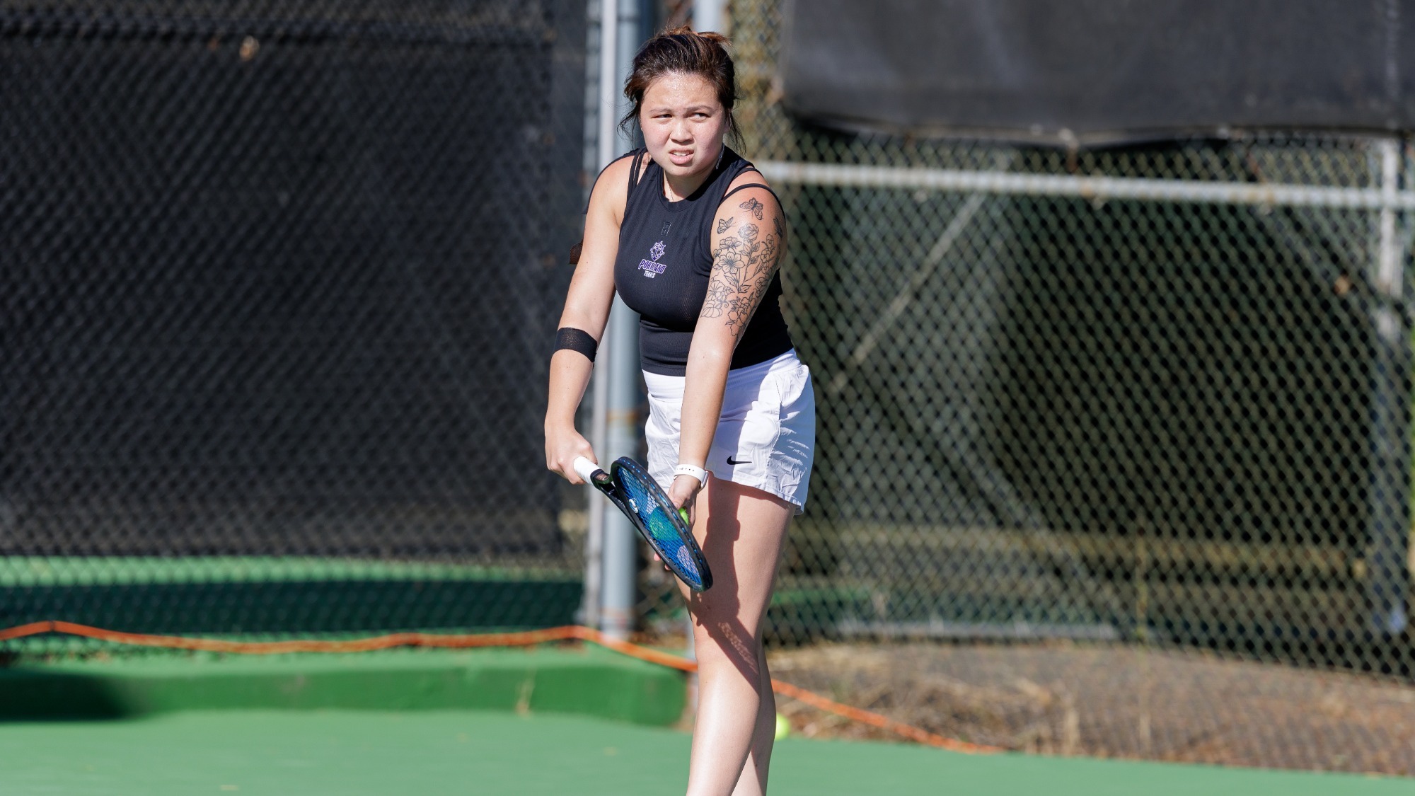 Kylie Canubida prepares to serve during a match vs. LMU at the 2026 WCC Tournament.