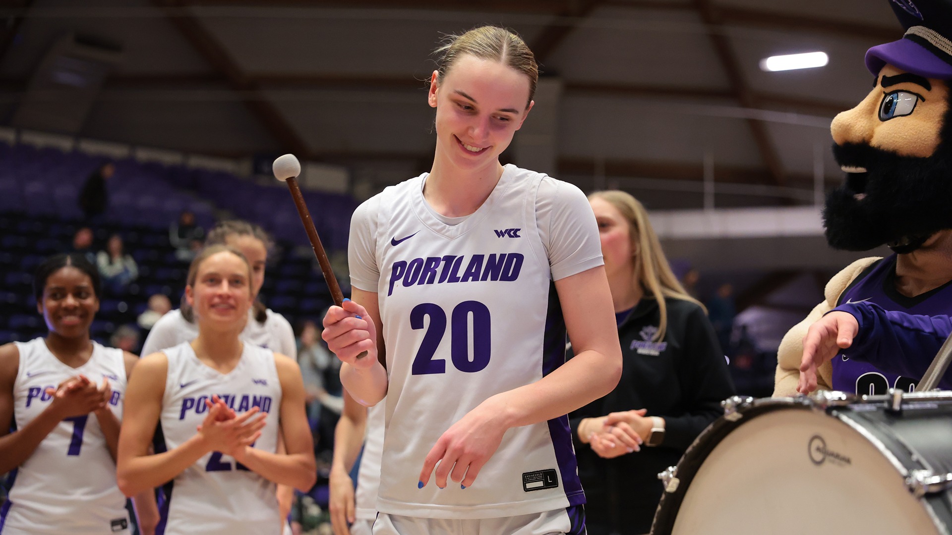 Lainey Spear bangs the drum after a win over Seattle U.