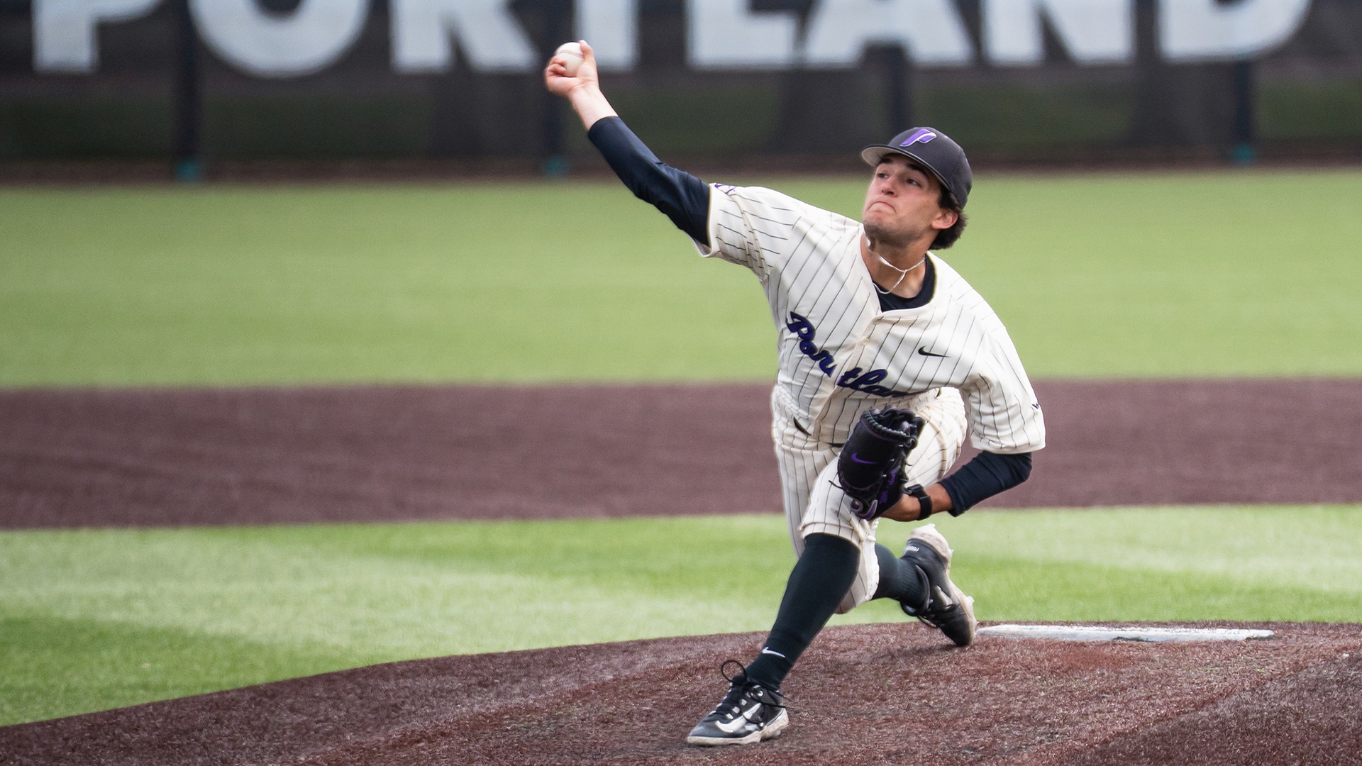 Labonte on the mound, throwing a pitch with force.