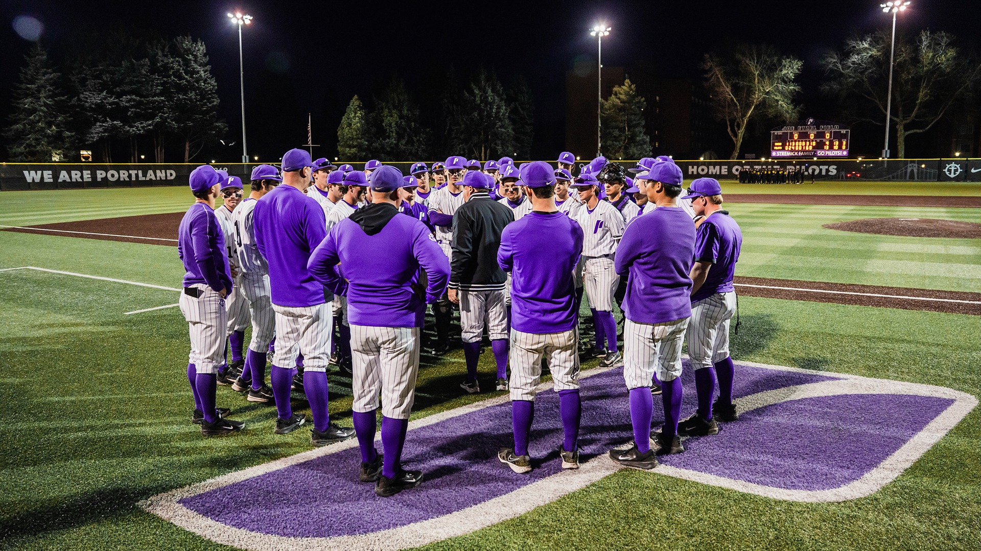 The Pilots gather around head coach Geoff Loomis postgame.