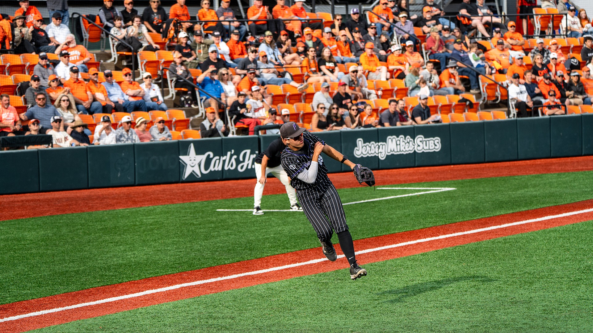 Cole Katayama-Stall makes the throw from third base.